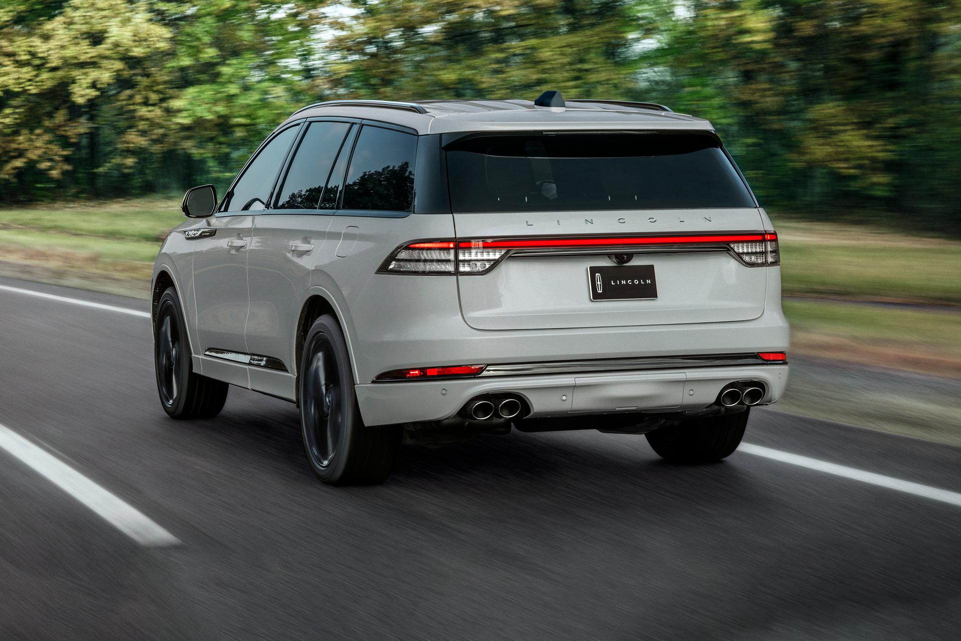 A 2027 Lincoln Aviator® SUV is being driven on a country road