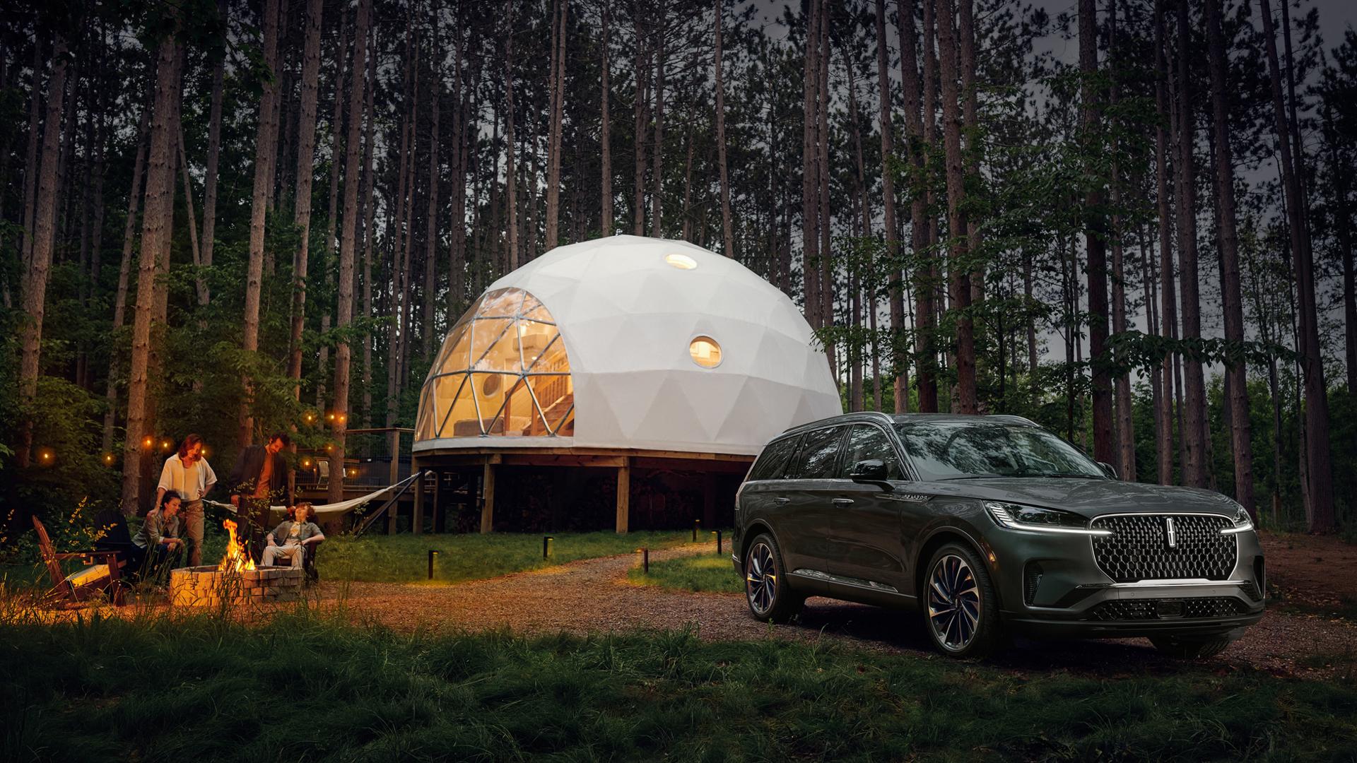 A family unwinds in the night at a luxury campsite