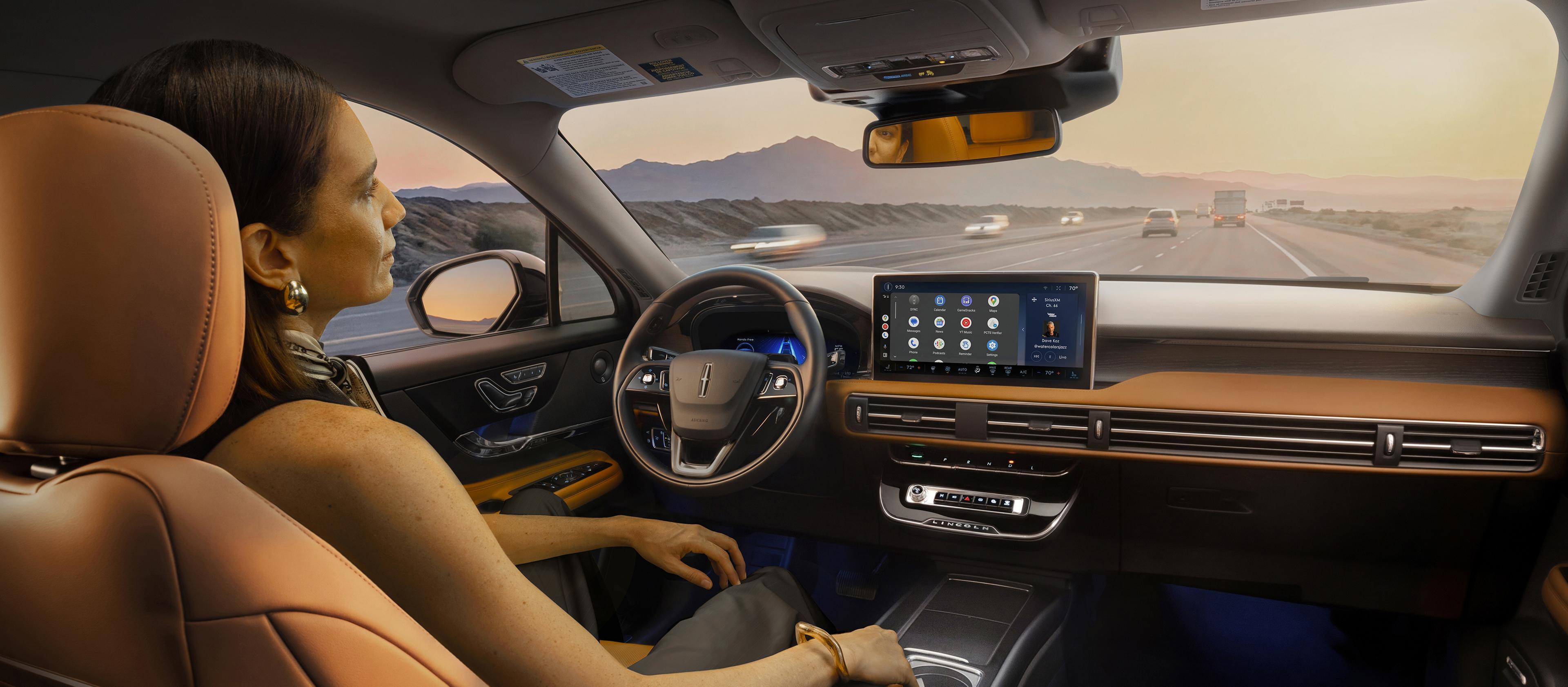 The driver of a 2027 Lincoln Corsair Hybrid makes use of Lincoln BlueCruise hands-free highway driving technology