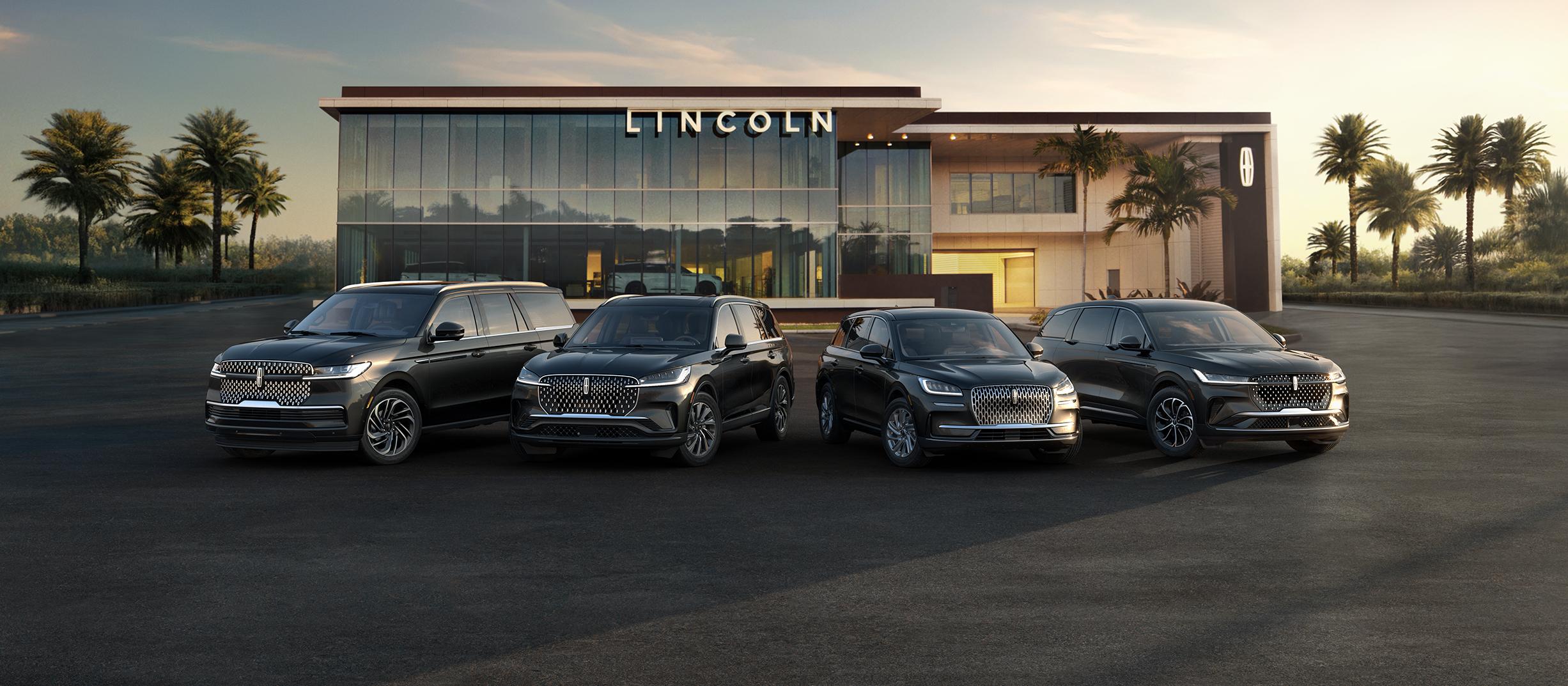 A group shot showcasing Lincoln SUVs parked in front of a Lincoln dealership.