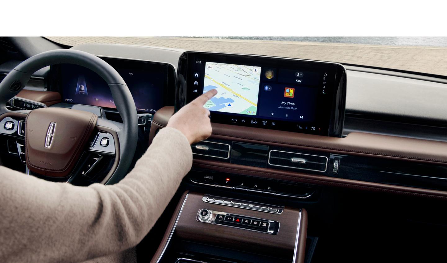 A man looking at a map on the center touch-screen.