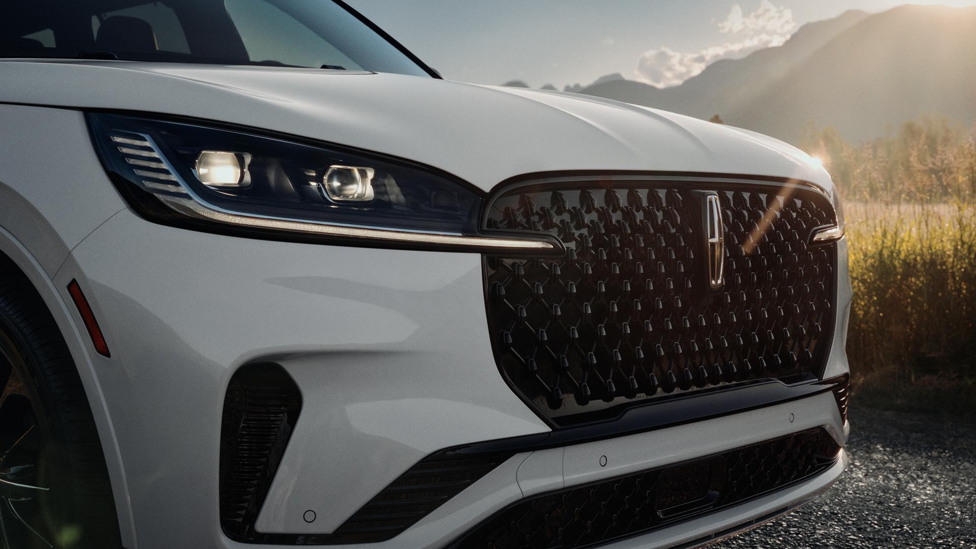 The LED headlamps of a 2027 Lincoln Aviator® SUV are illuminated