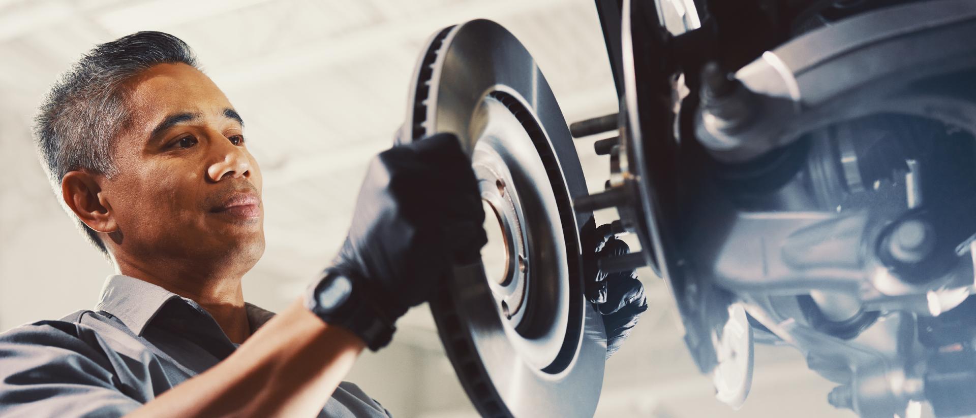 A Lincoln technicican servicing the brakes on a Lincoln vehicle.
