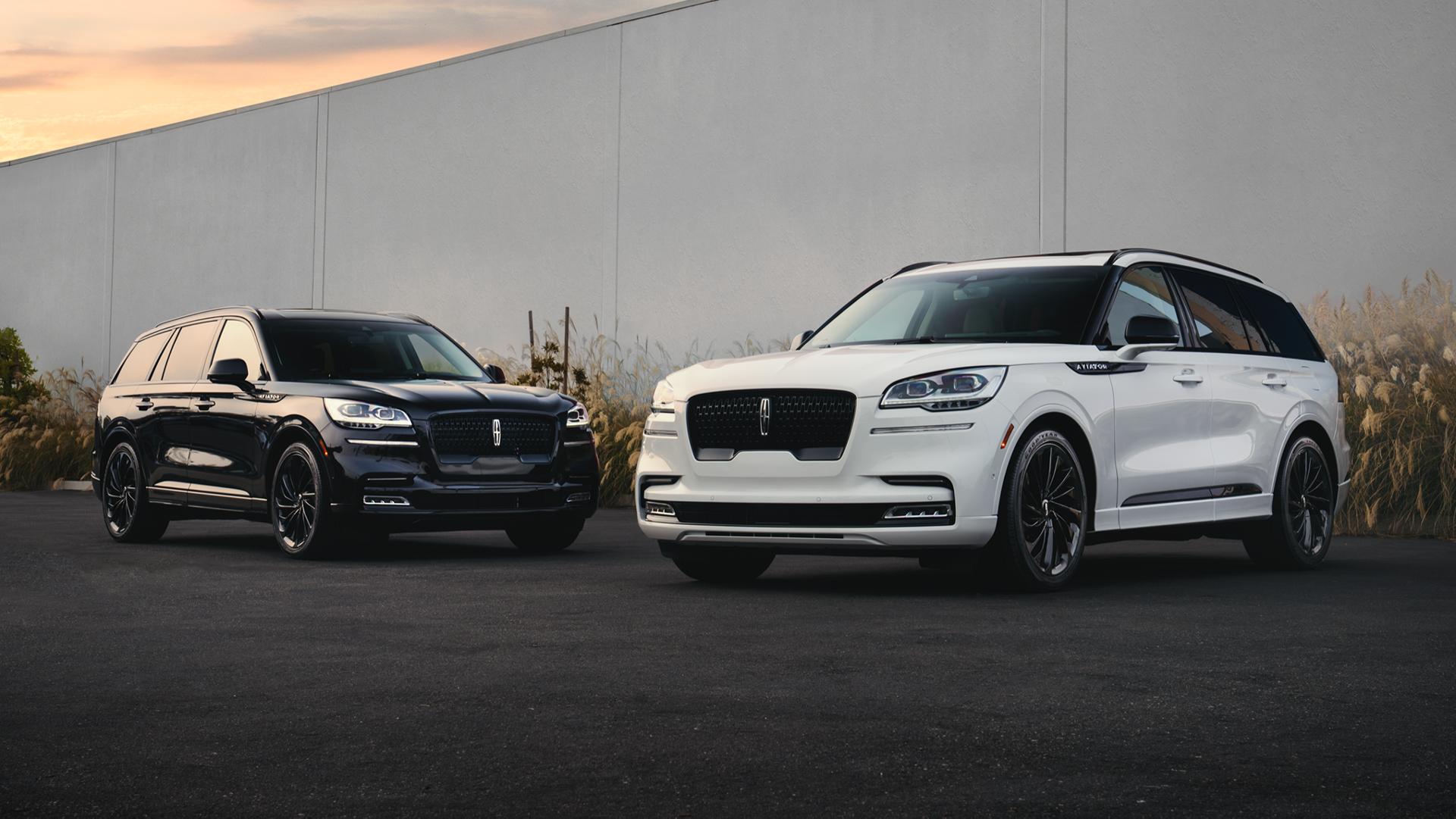 Two Lincoln vehicles parked side to side