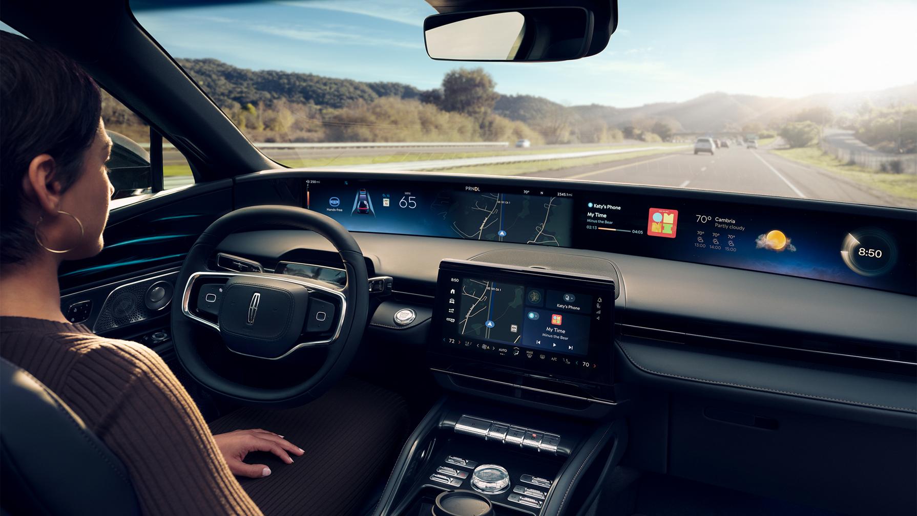 A woman sitting inside the Lincoln Nautilus® SUV using the BlueCruise feature