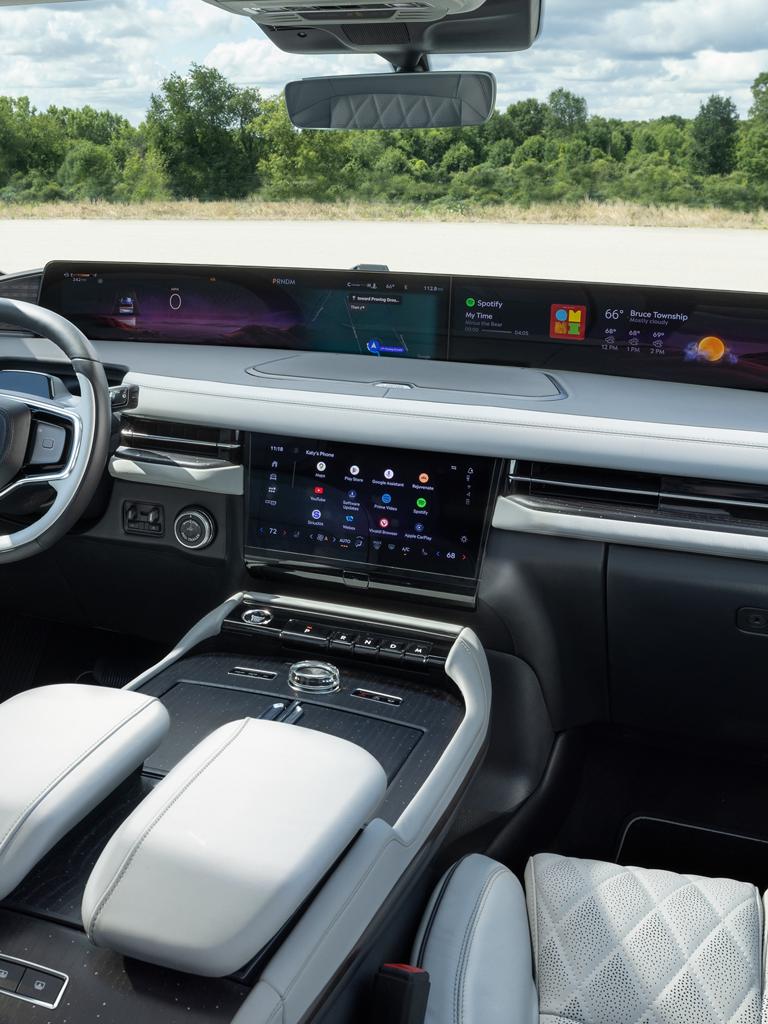 An interior driving shot of the 2027 Lincoln Navigator® showing the driver using voice-activated Google Assistant
