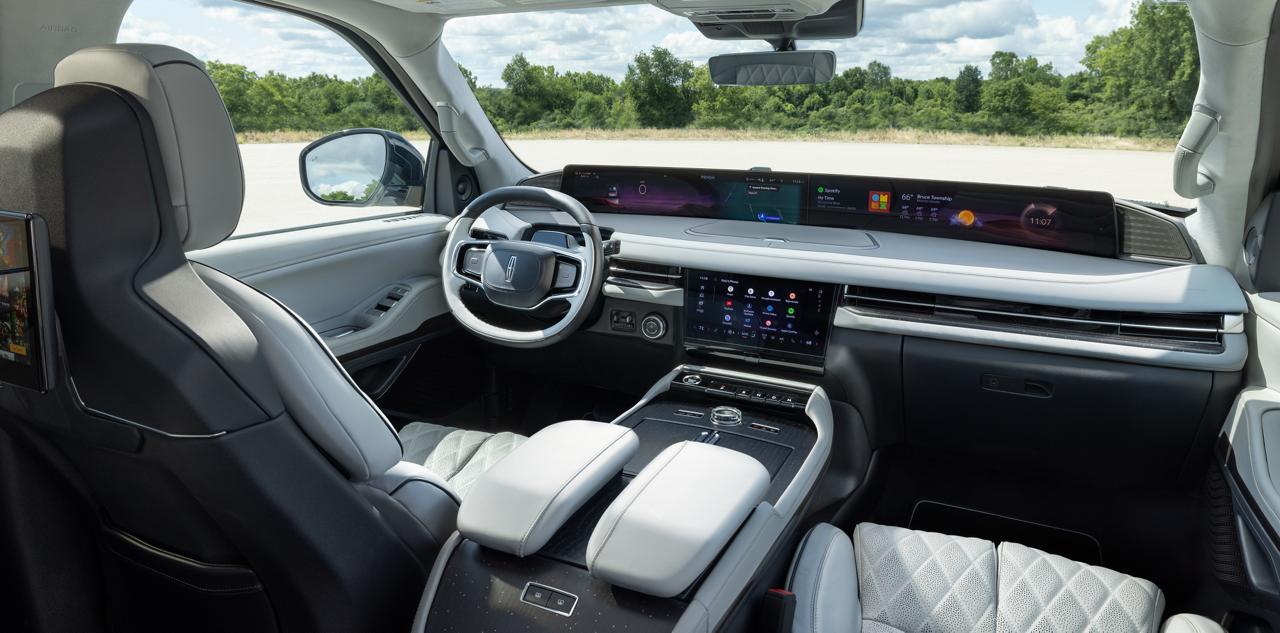 An interior view of a 2027 Lincoln Navigator® SUV being driven on a country road