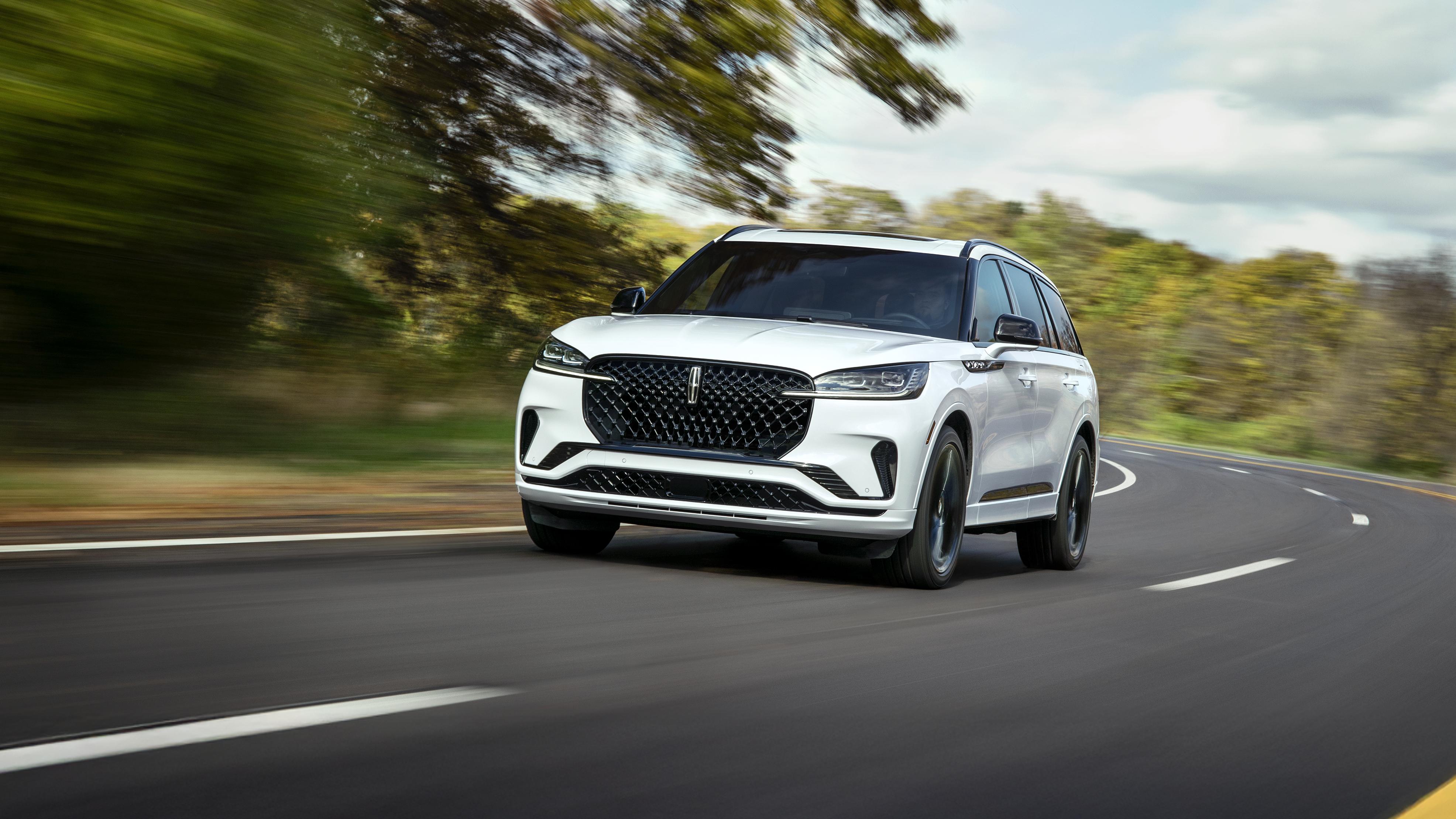 A 2025 Lincoln Aviator Reserve being driven on a curved road