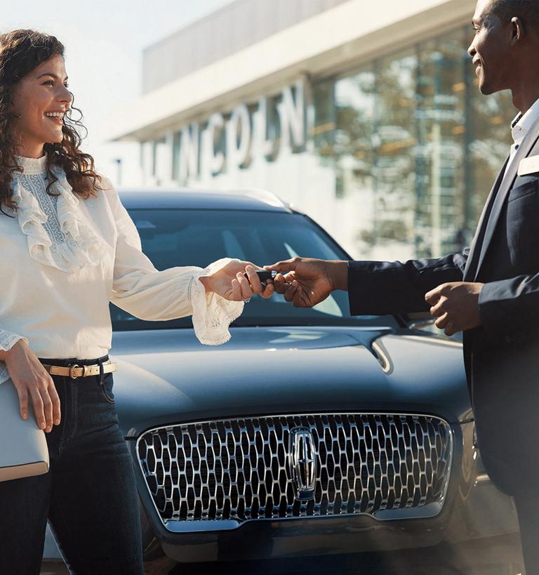Un cliente de Lincoln recibe sus llaves de un asesor de servicio