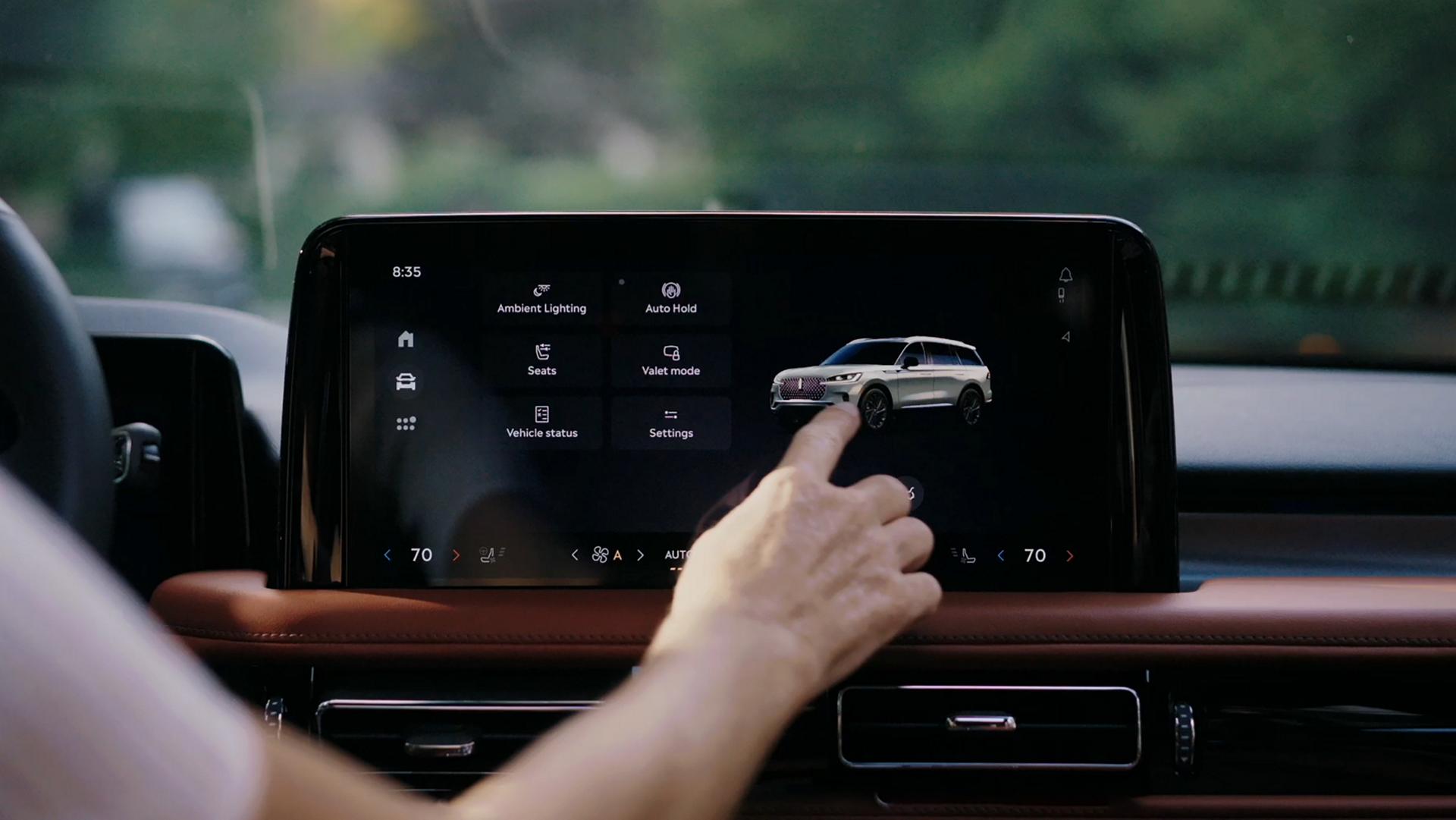 A person interacts with the center touchscreen of a 2027 Lincoln Aviator® SUV