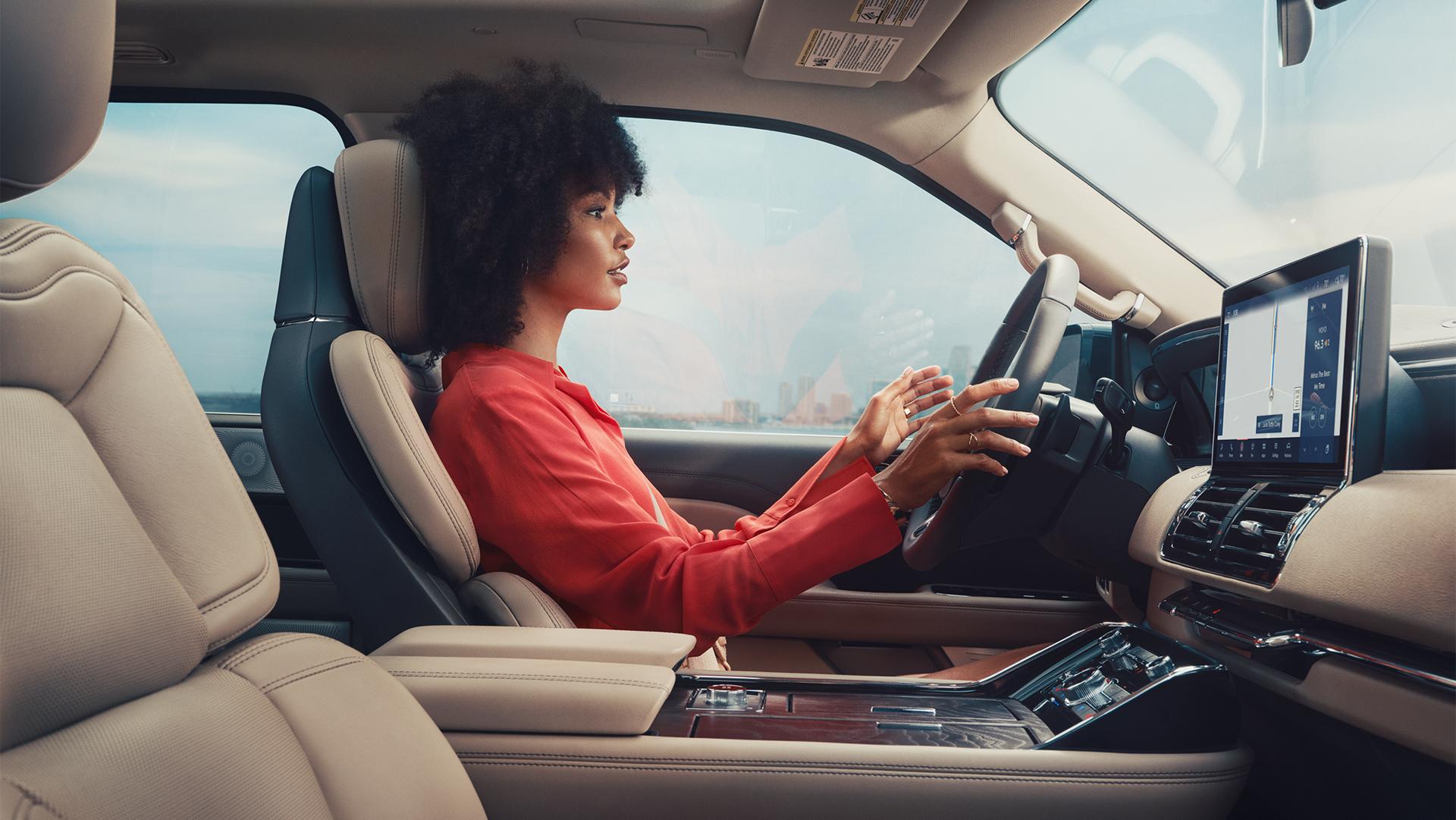 A woman sitting inside the Lincoln Navigator using the BlueCruise feature