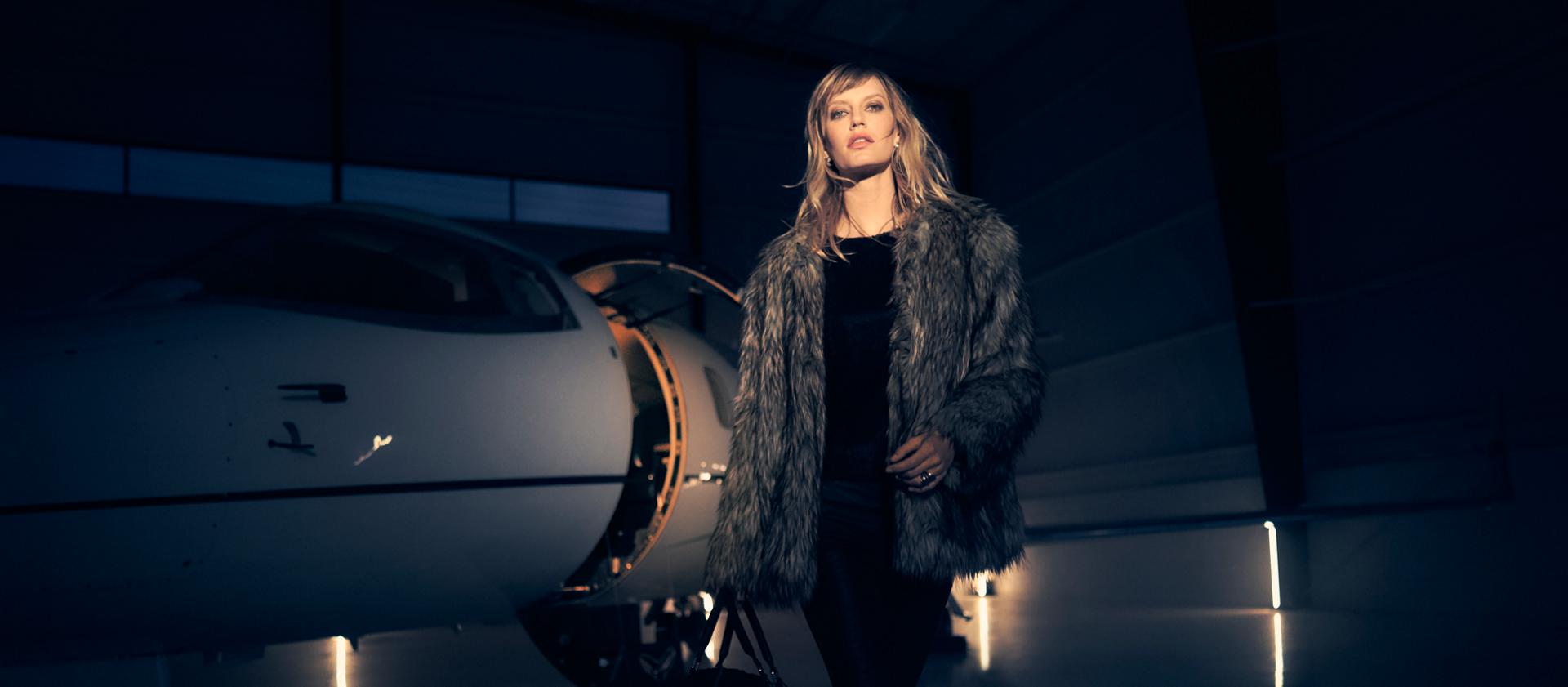 A woman is showing leaving a private jet to align with the exclusivity of 2025 Lincoln Black Label