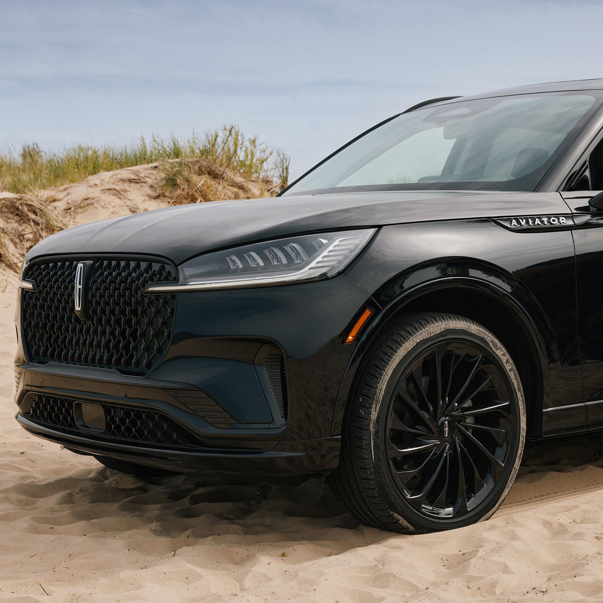 A 2027 Lincoln Aviator® SUV is parked on a seaside overlook