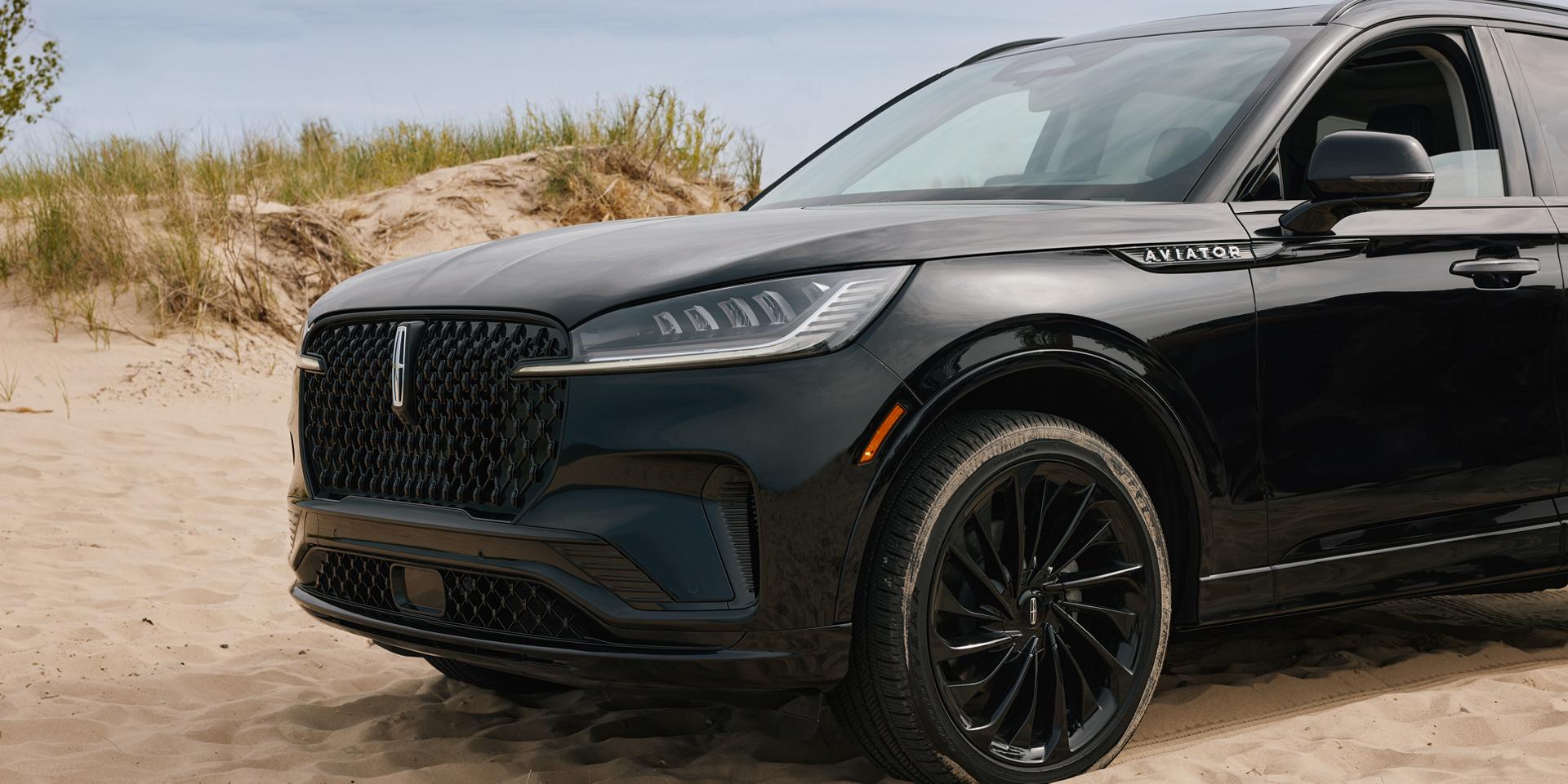 A 2027 Lincoln Aviator® SUV is parked on a seaside overlook