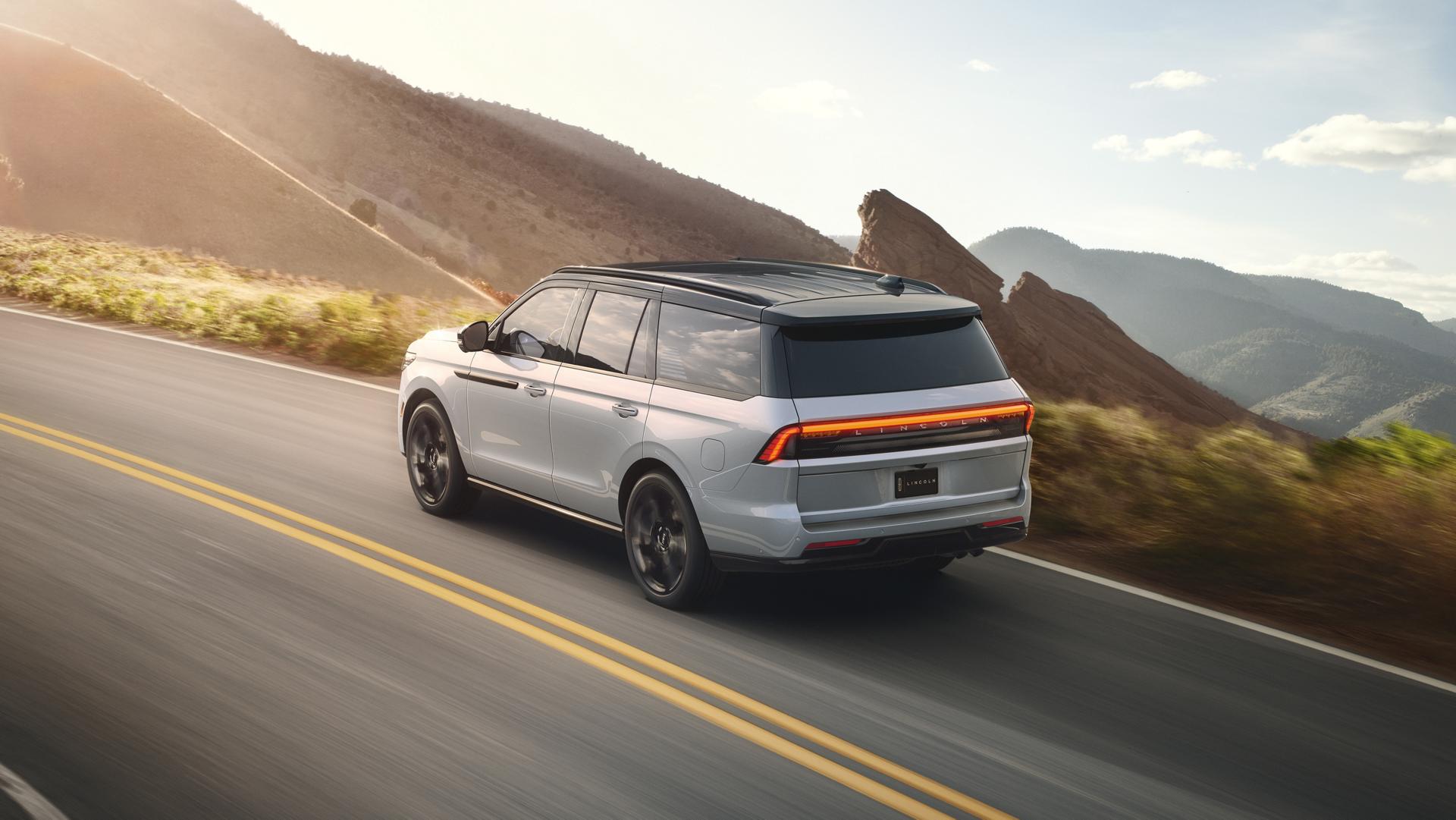 A 2027 Lincoln Navigator® SUV is being driven on a winding mountain road