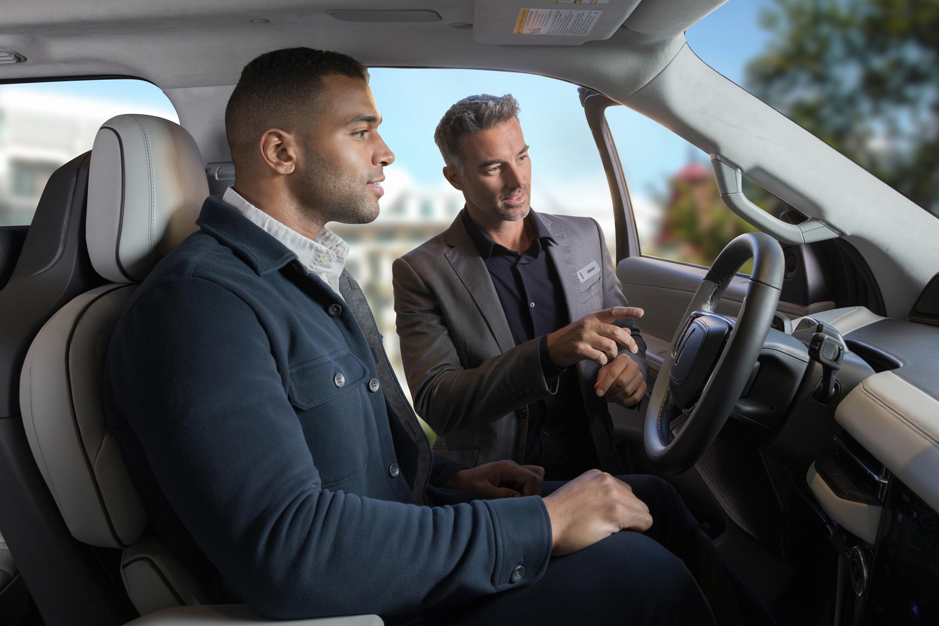 A Lincoln representative interacts with a client inside a Lincoln SUV
