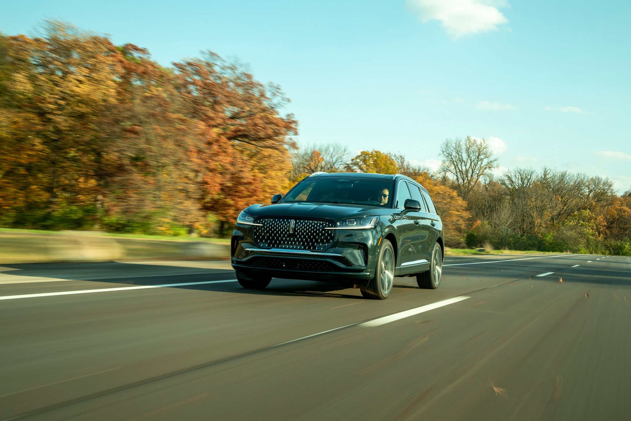A Lincoln Black Label Aviator® SUV is parked in a private airplane hangar.