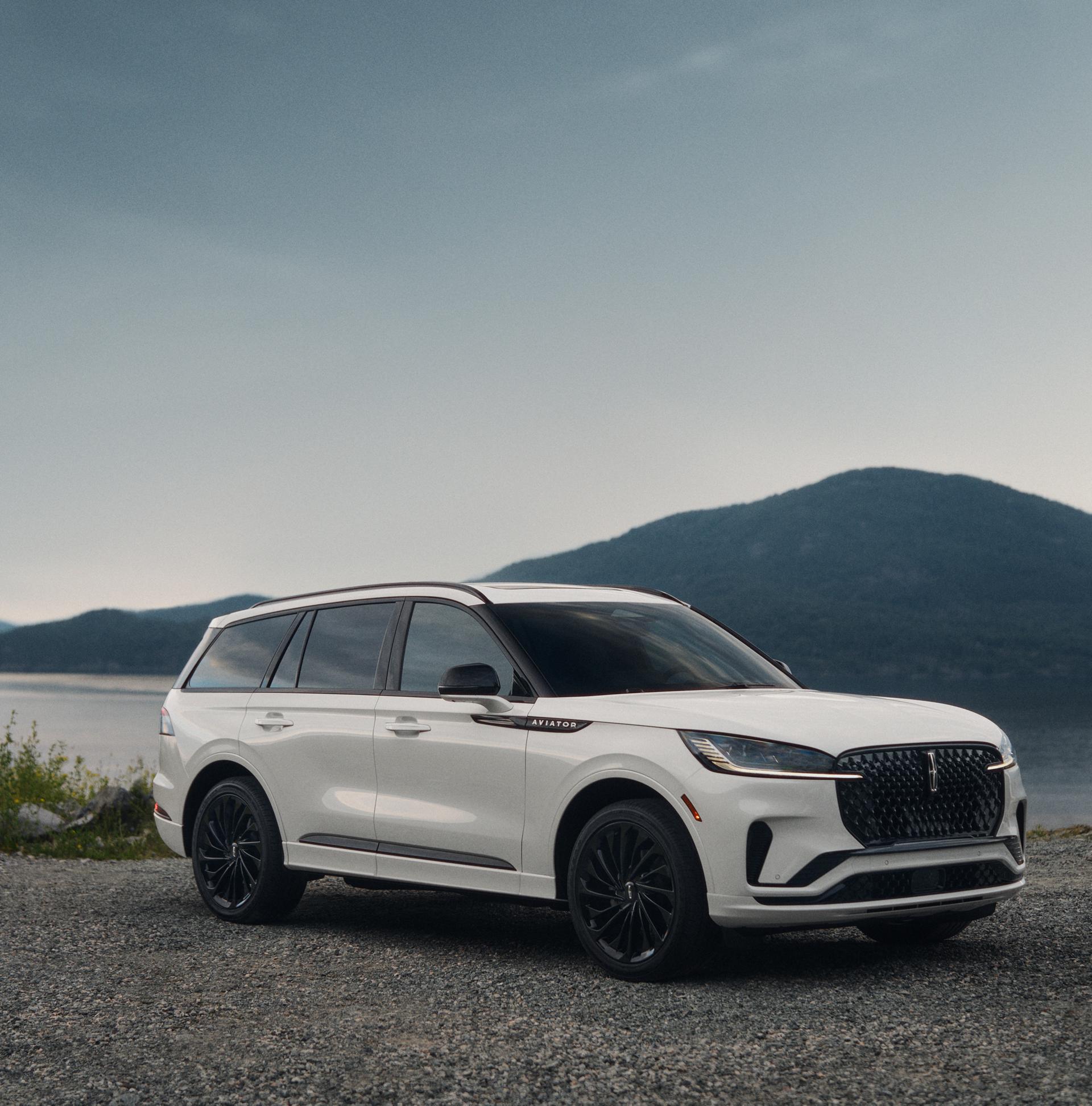 A 2027 Lincoln Aviator® SUV is parked near a lakeshore