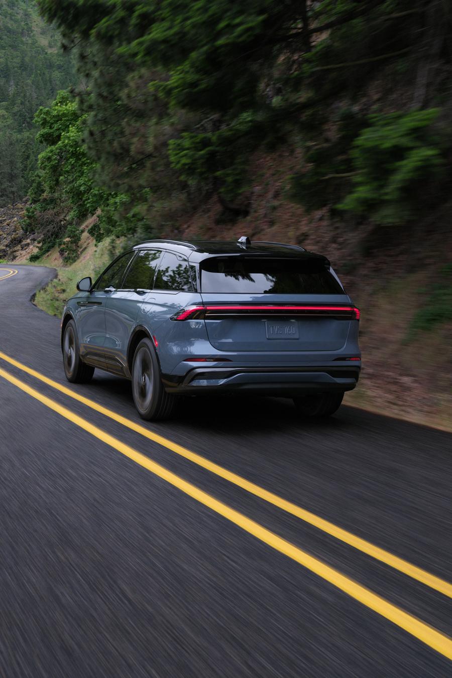 A 2026 Lincoln Nautilus® SUV is being driven through a sharp turn on a rural road