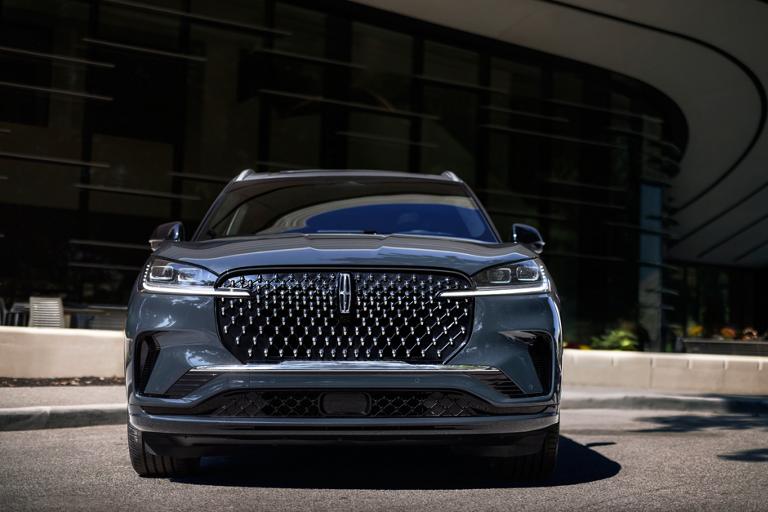 The dazzling grille of a 2026 Lincoln Black Label Aviator® SUV sparkles in the sunlight