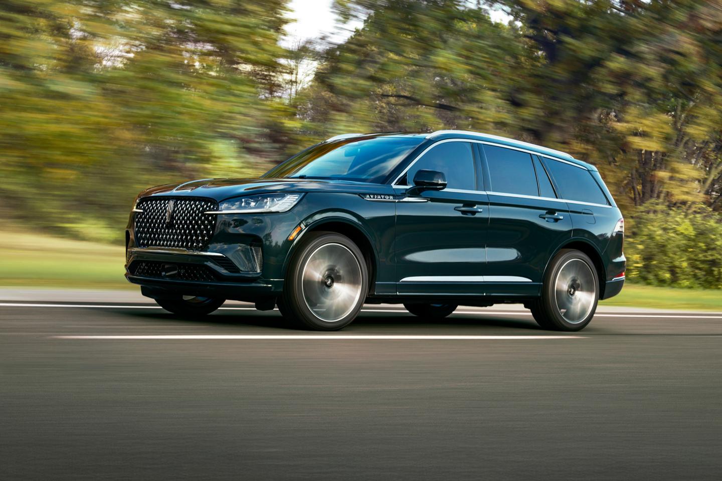 The 2025 Lincoln Aviator driving down a road.