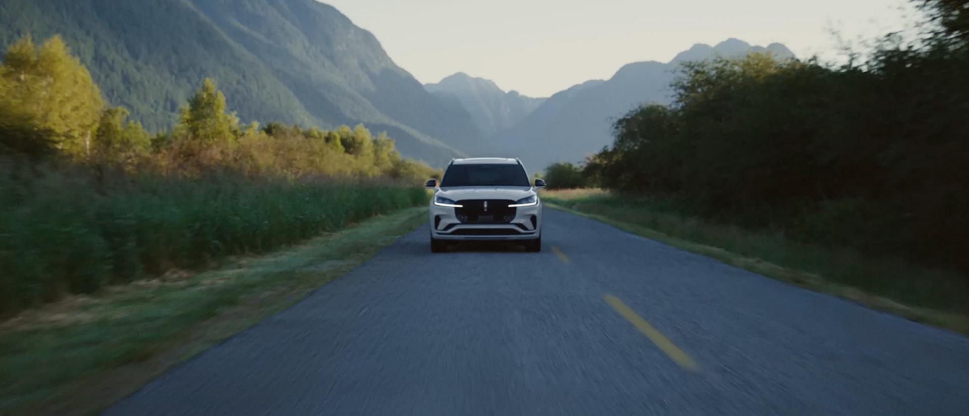 A 2027 Lincoln Aviator® SUV is being driven on a country road