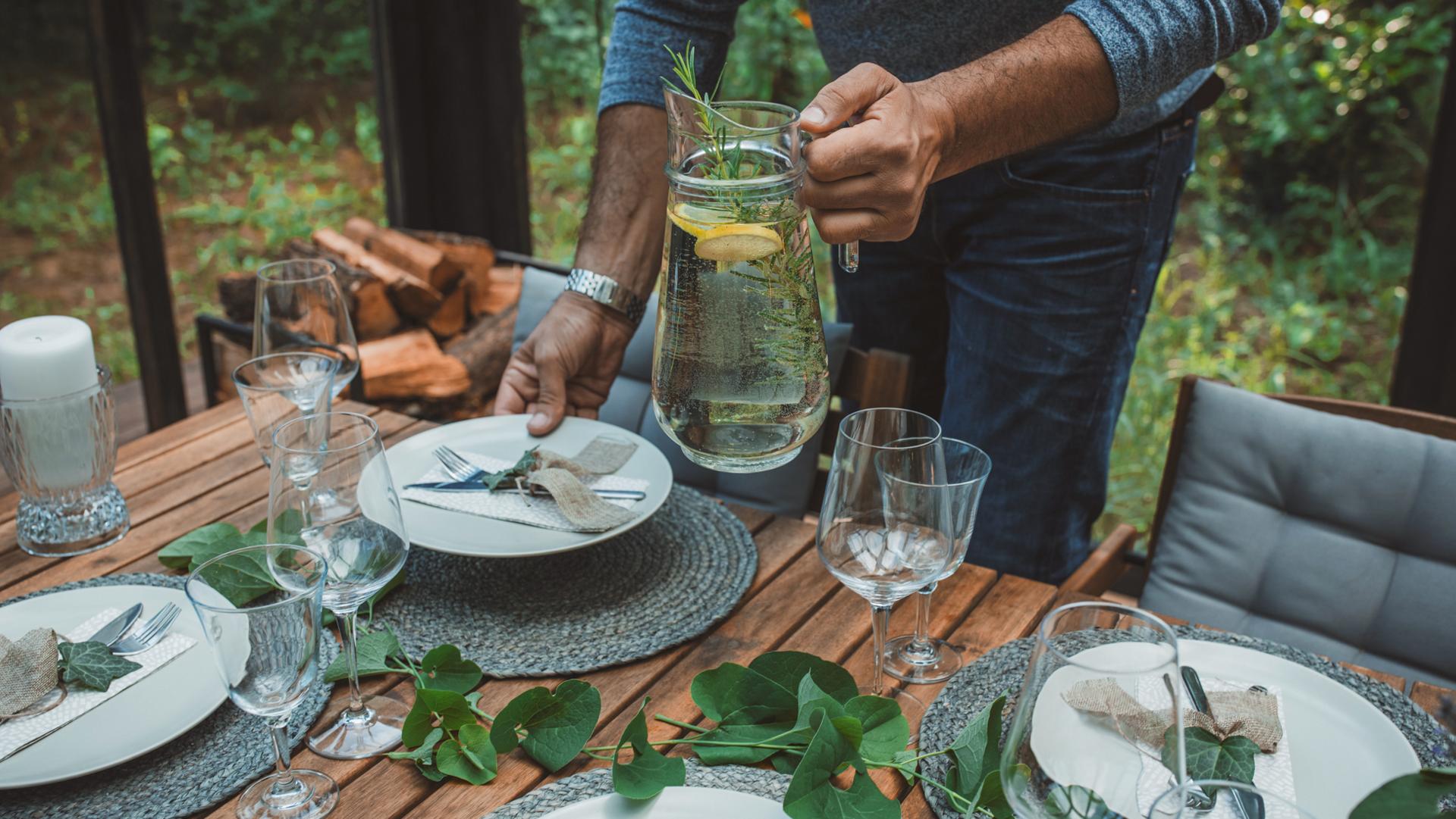 A dining table is being set to replicate the inspiration for the Lincoln Black Label invitation theme