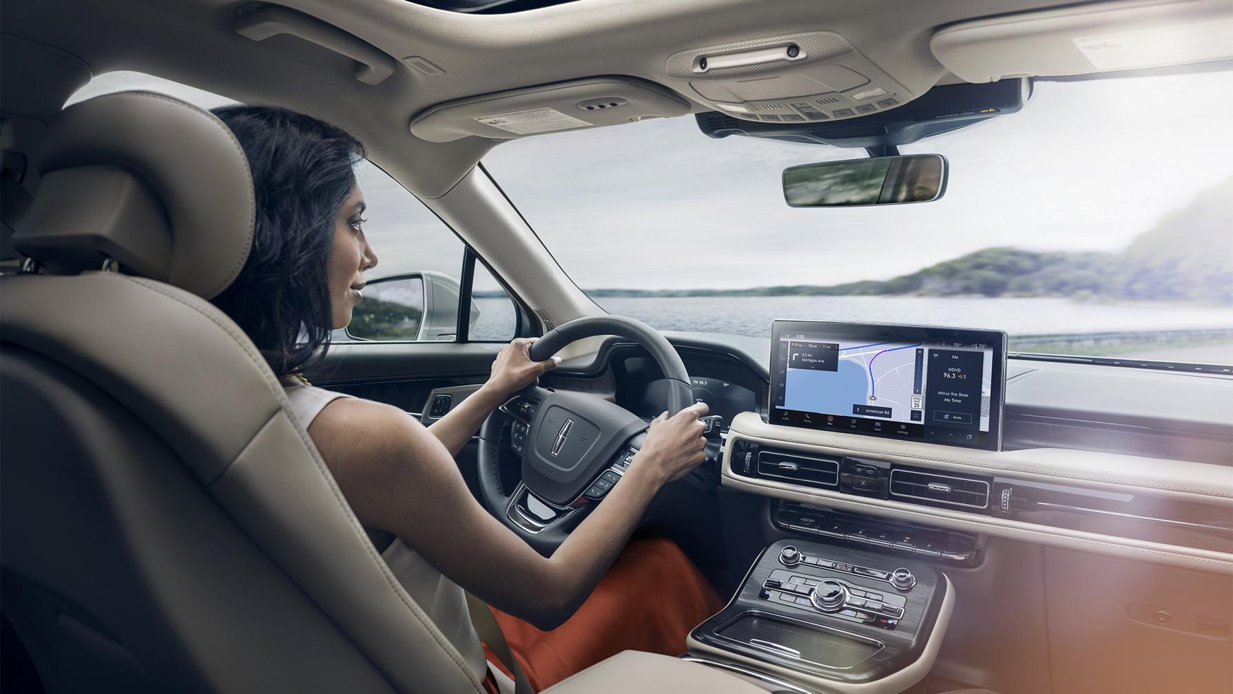 A woman driving the Lincoln Nautilus® SUV