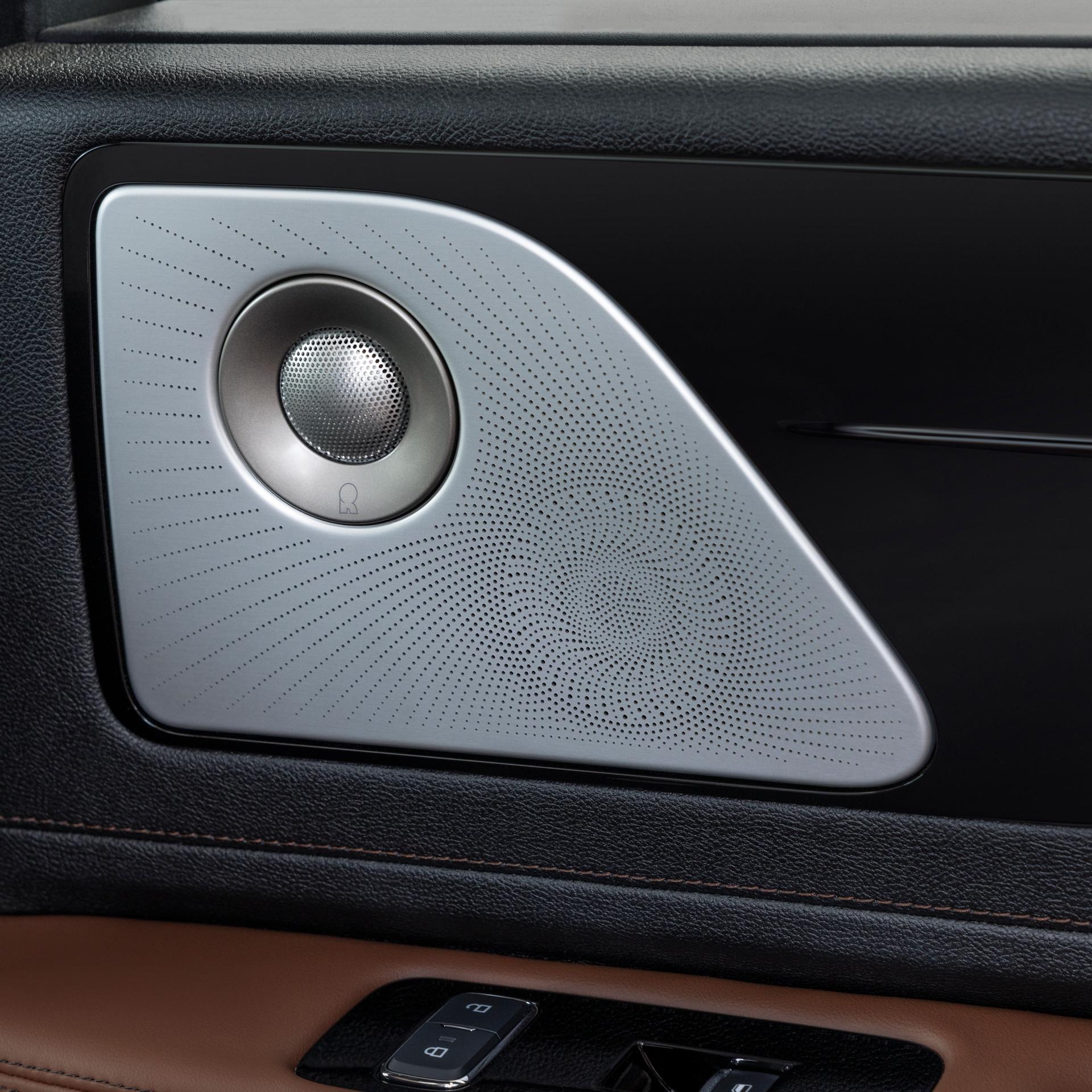 A Revel® speaker is shown on the interior door pane of a 2026 Lincoln Aviator® SUV