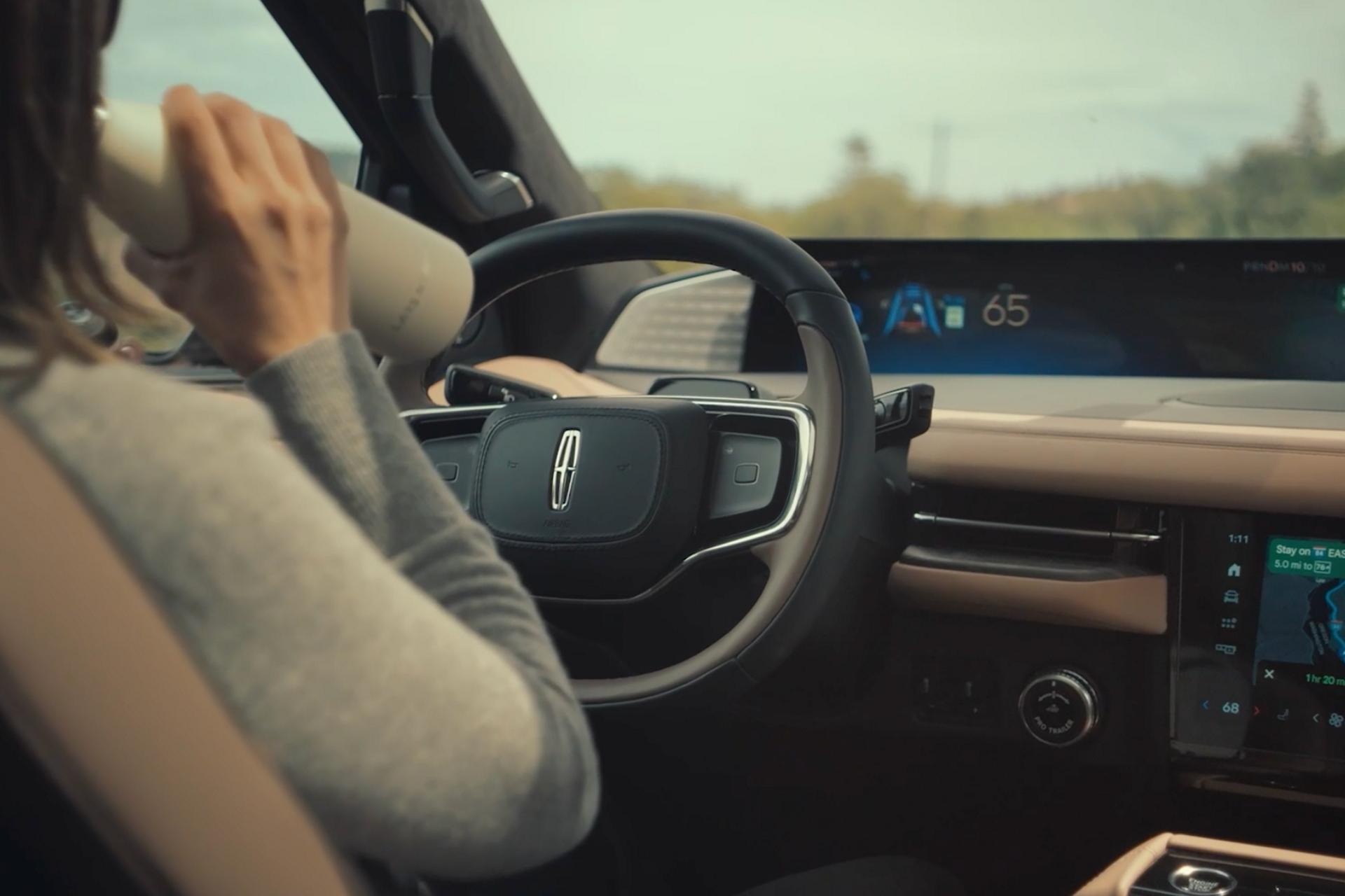 The driver of a 2027 Lincoln Navigator® SUV makes use of Lincoln BlueCruise hands-free highway driving technology