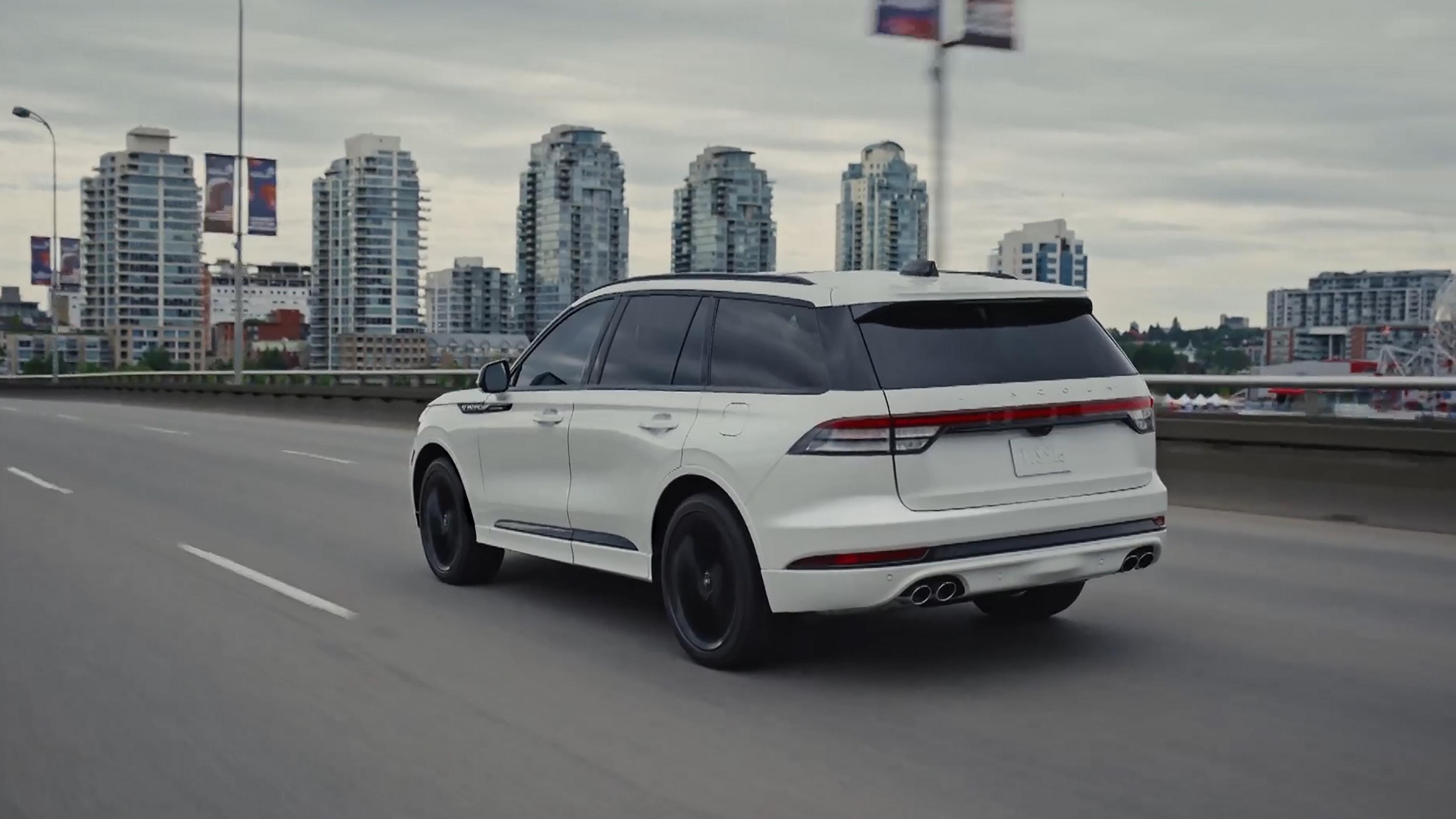 A 2027 Lincoln Aviator® SUV is being driven in an urban setting