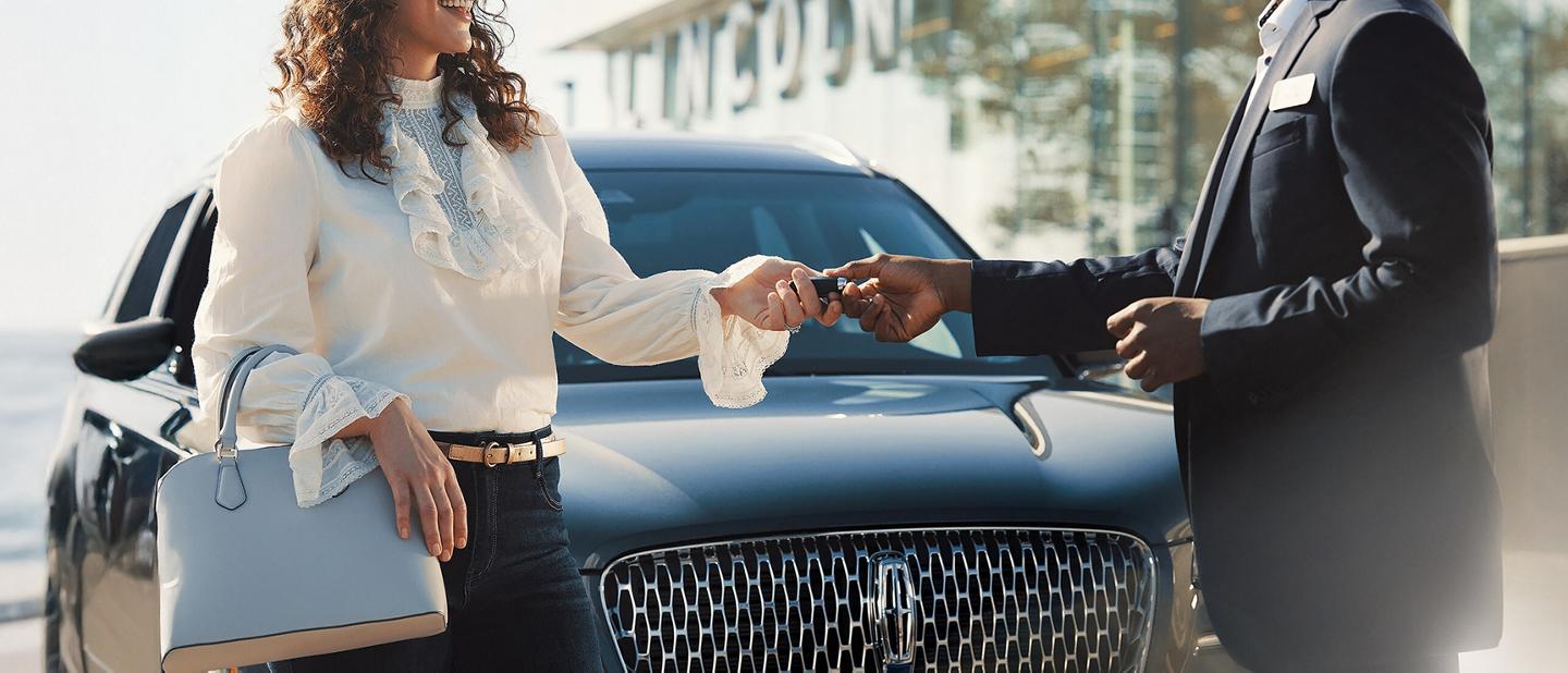 A Lincoln customer receives their keys back from a service advisor