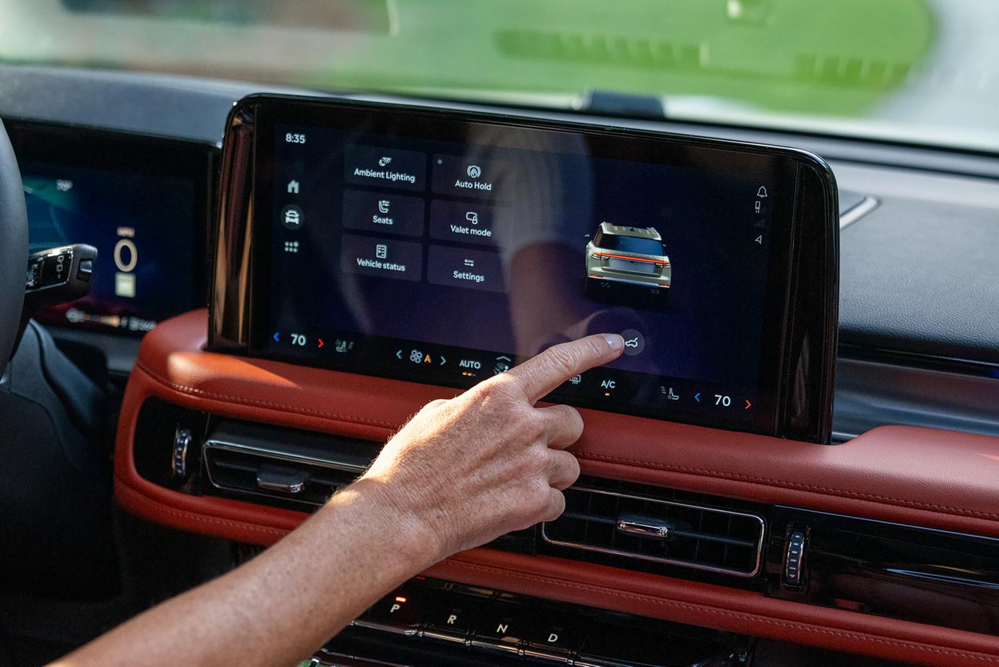 A man using the center touch screen.
