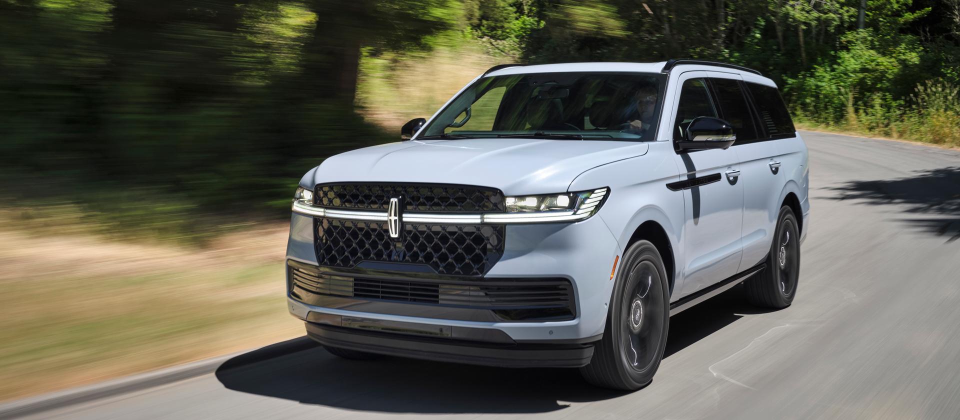 Una SUV Lincoln Navigator® 2026 circulando por un camino rural