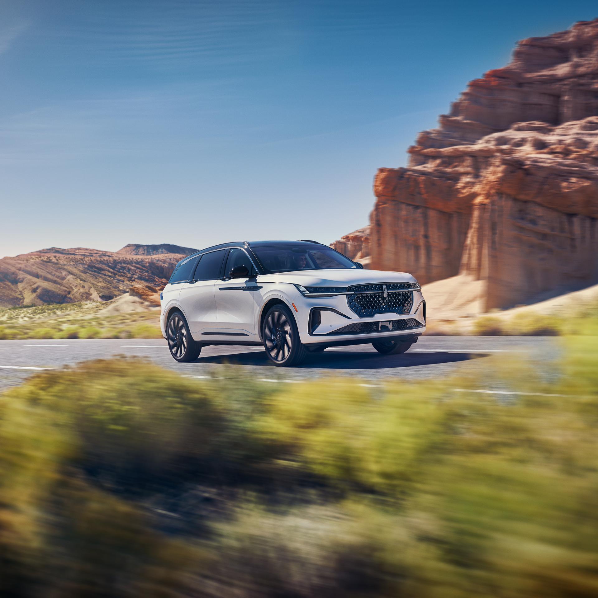 A 2026 Lincoln Nautilus® SUV is being driven on a highway in the desert