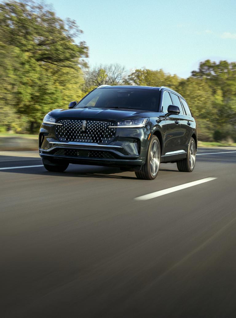The Lincoln Aviator driving down a road.
