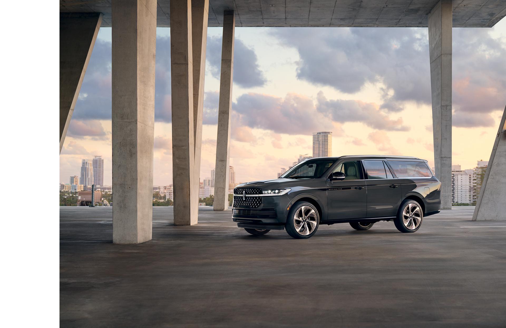 The 2026 Lincoln Navigator parked in a parking garage with a cityscape in the background.