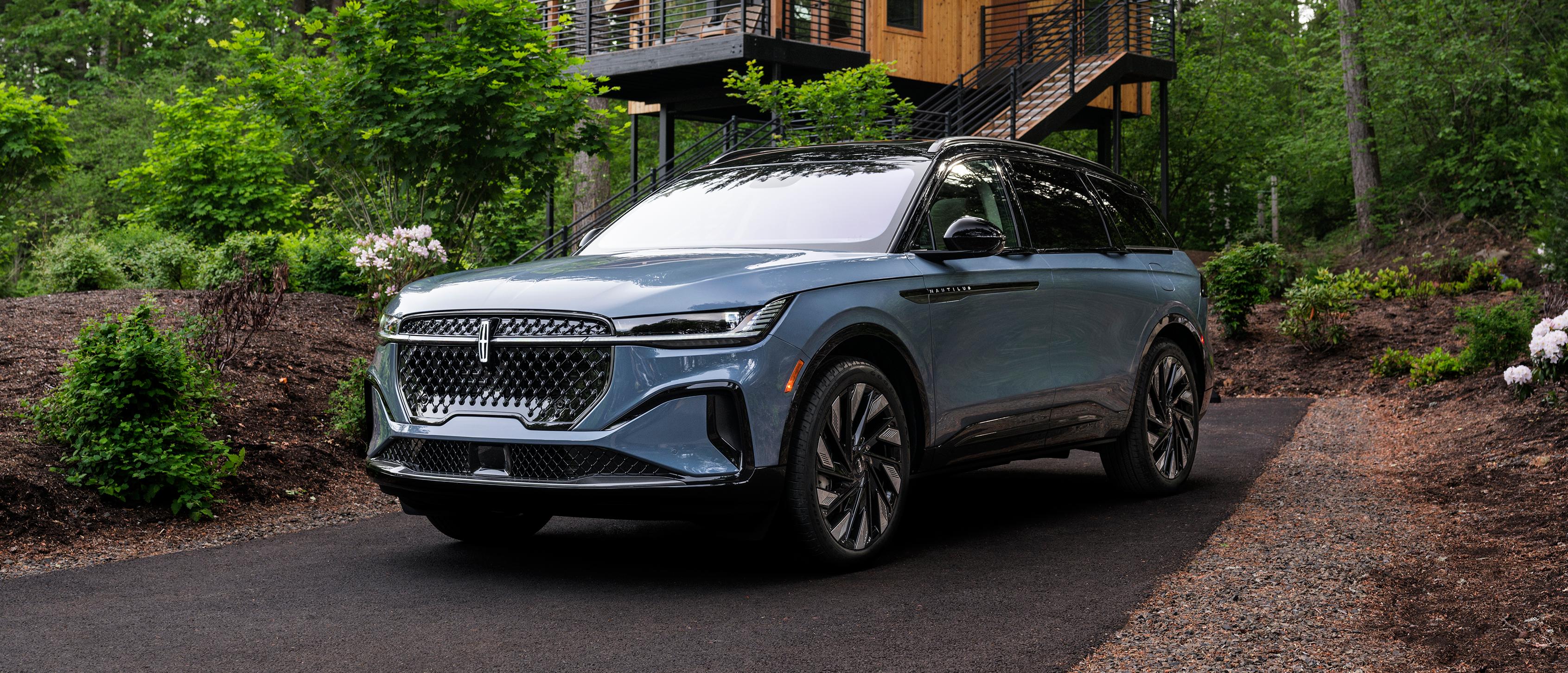 The front of a 2026 Lincoln Nautilus® SUV parked in front of a house.