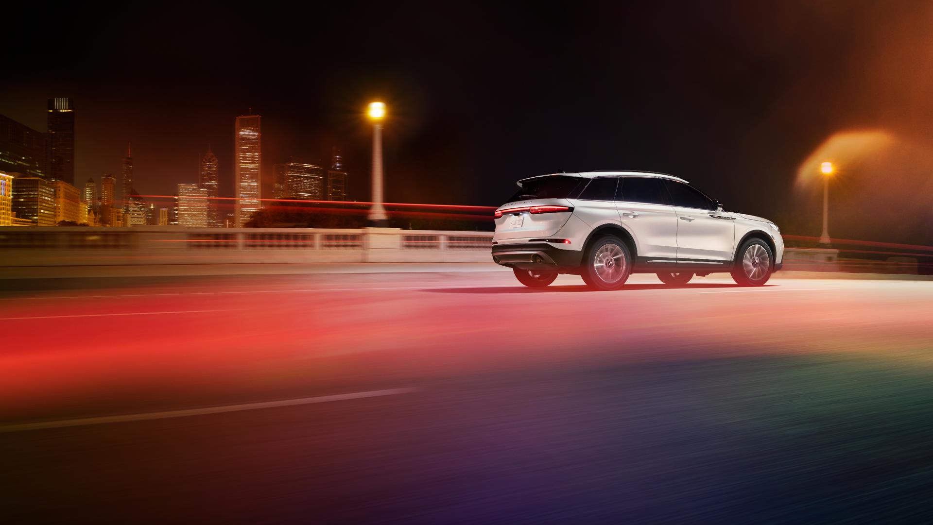The 2026 Lincoln Corsair driving down a road in the night.