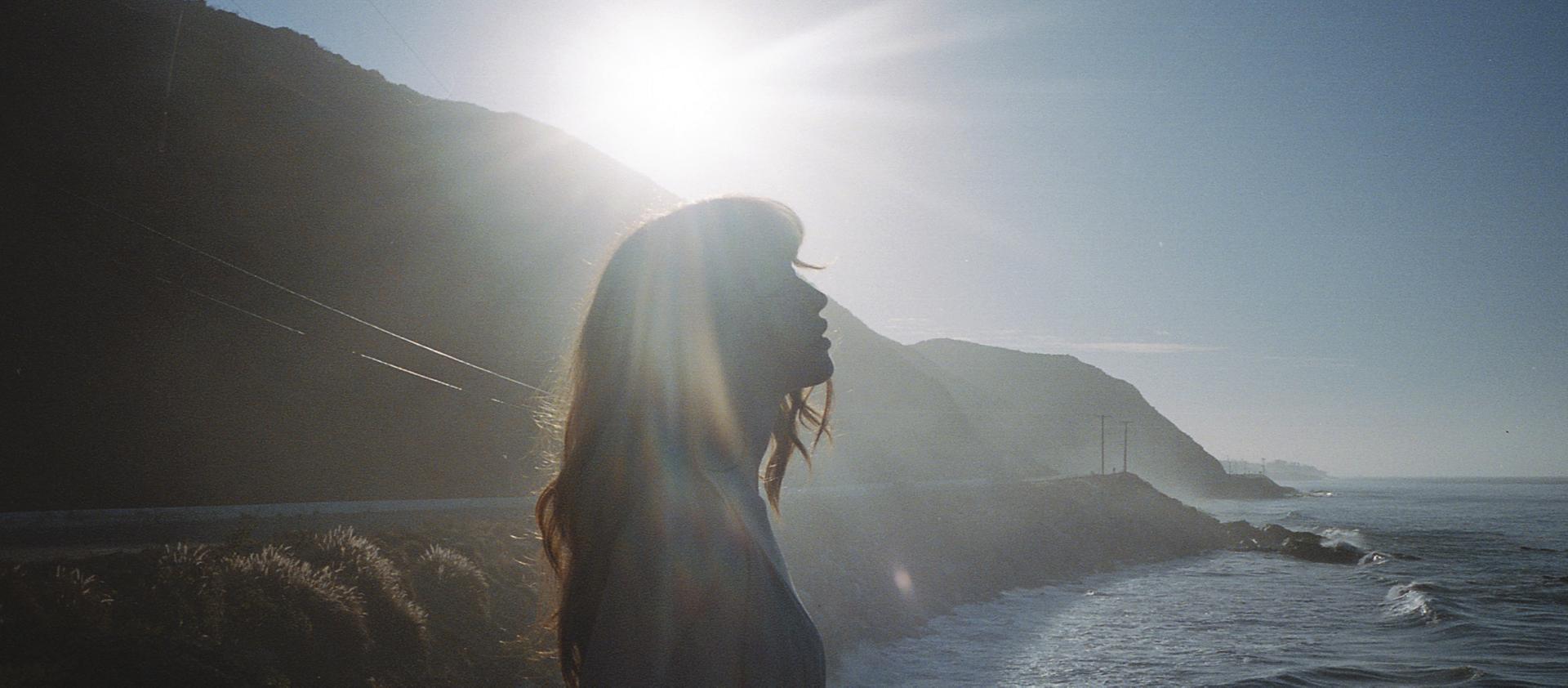 A woman enjoys a moment on a seaside overlook