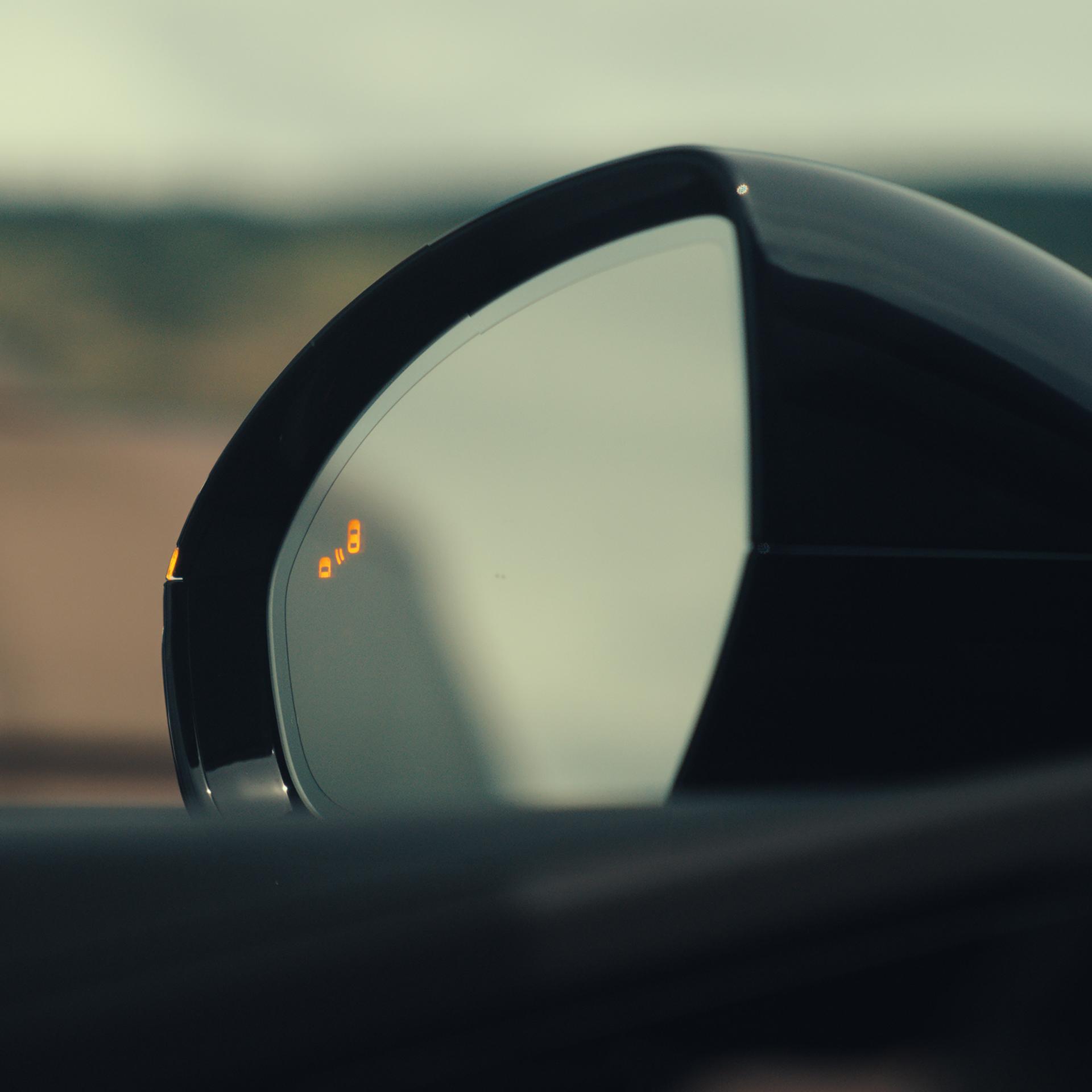 The driver's sideview mirror of a 2026 Lincoln Nautilus® SUV indicates that a vehicle is in its blind spot