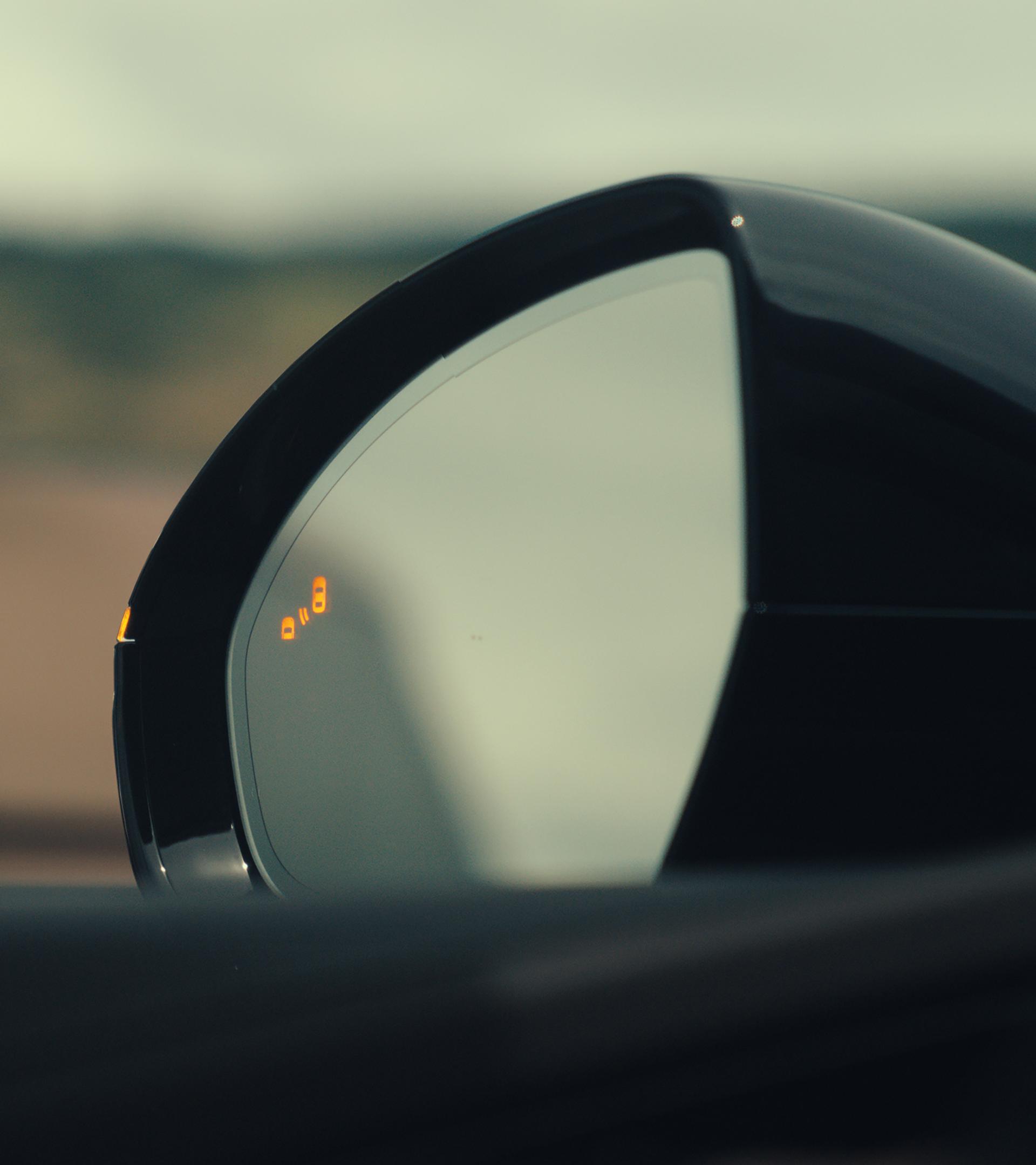 The driver's sideview mirror of a 2026 Lincoln Nautilus® SUV indicates that a vehicle is in its blind spot