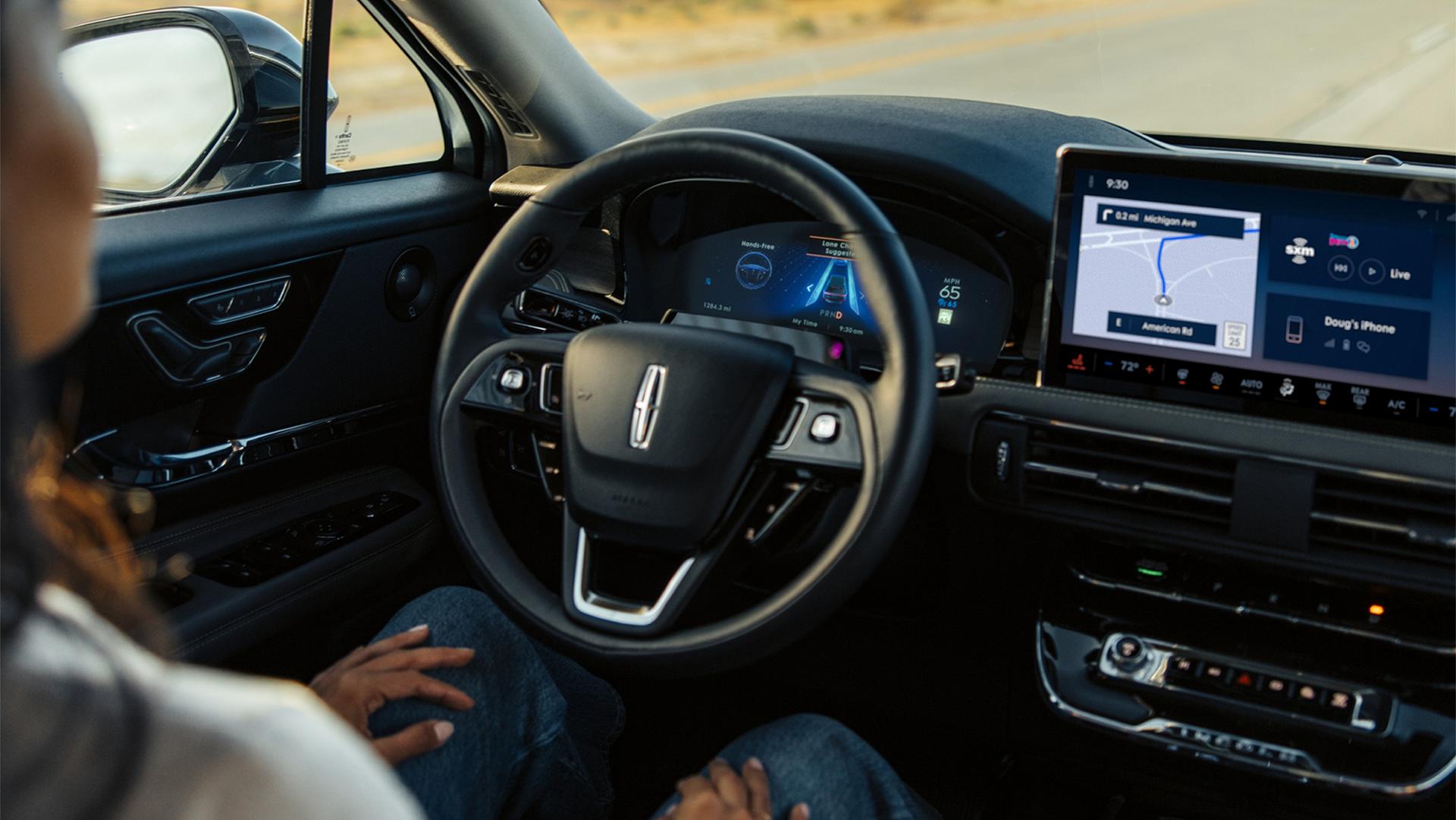A woman sitting inside the Lincoln Corsair® SUV using the BlueCruise feature