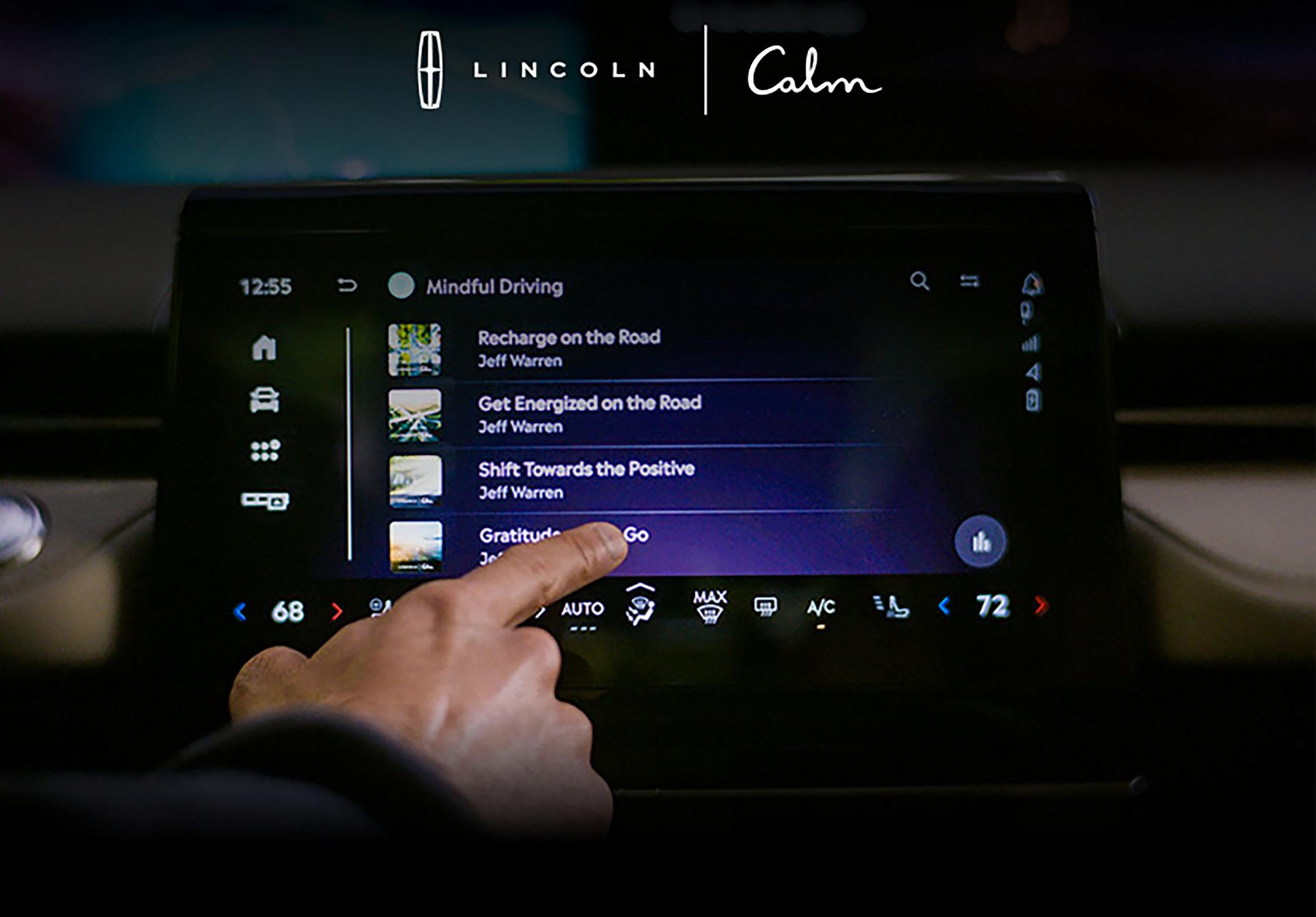  A finger interacts with an in-vehicle touchscreen interact with the calm app