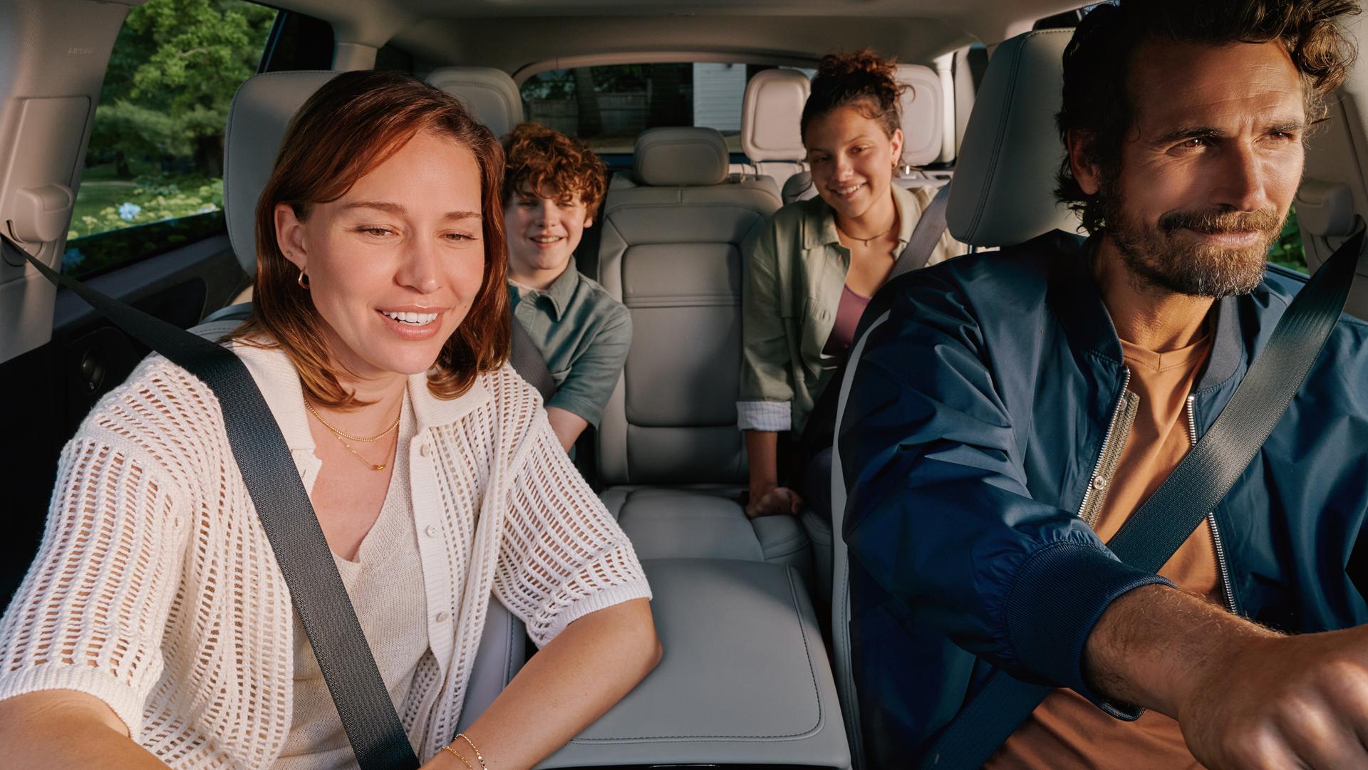 A family is seated comfortably in the front and middle rows of 2027 Lincoln Aviator® SUV