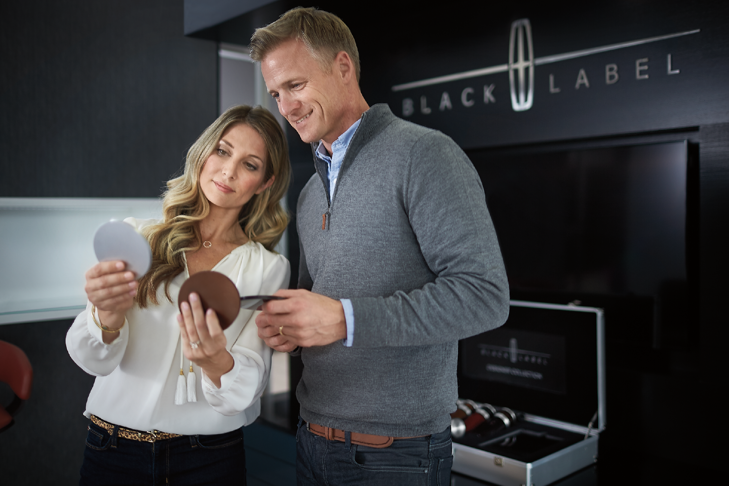 A man and a woman viewing different paint chips.