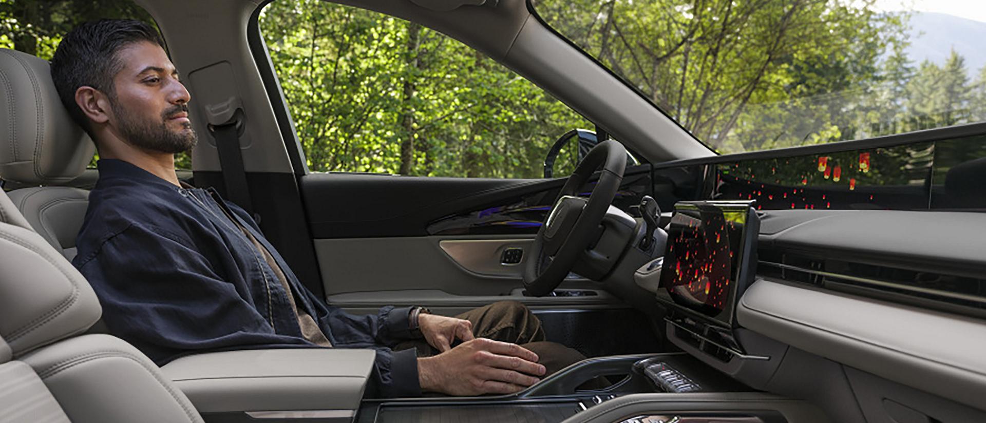 A person seated in the drivers seat of a 2026 Lincoln Nautilus® SUV enjoys Lincoln Rejuvenate