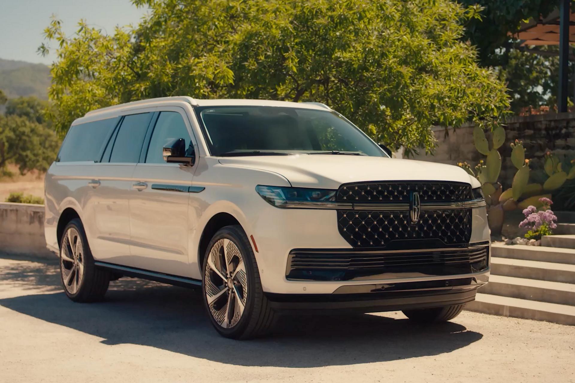 A 2027 Lincoln Navigator® SUV is parked in the driveway of a country retreat