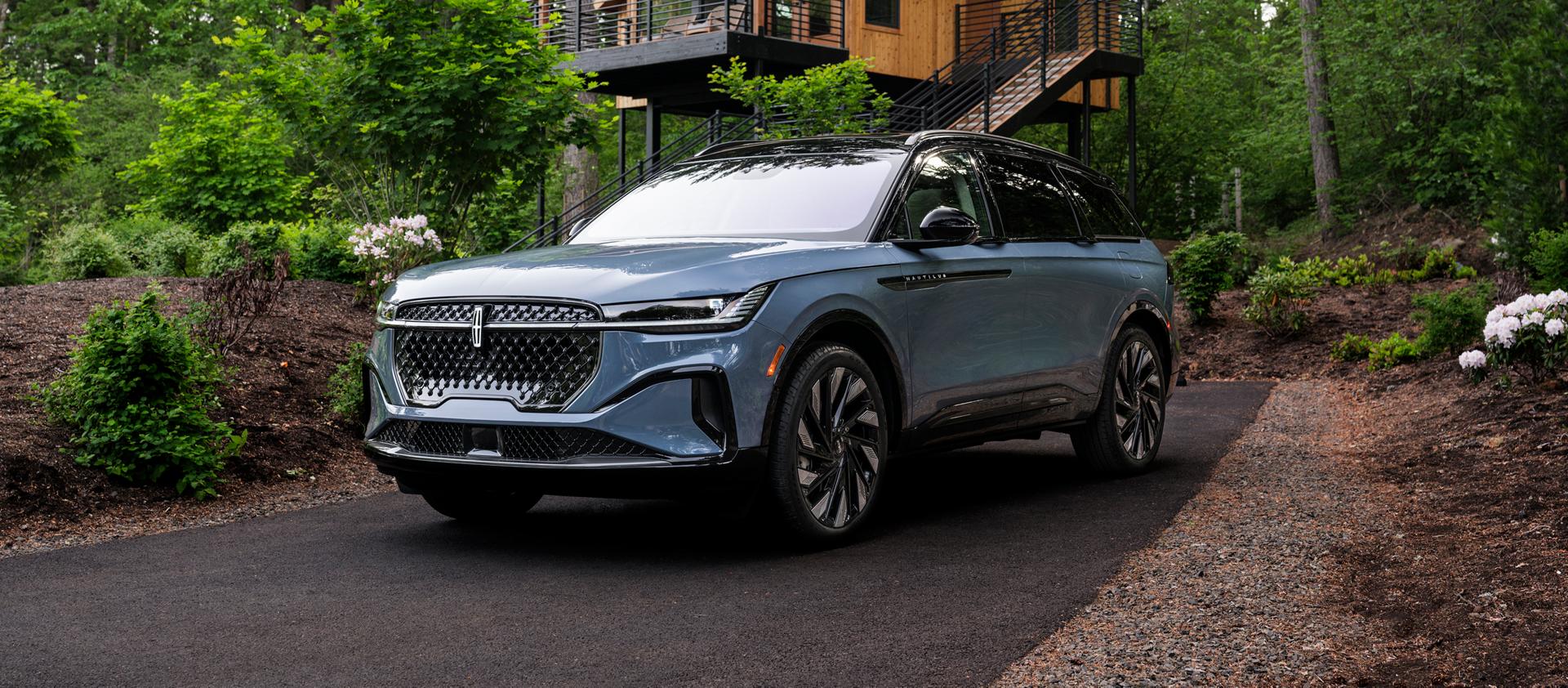 The front of a 2026 Lincoln Nautilus® SUV parked in front of a house
