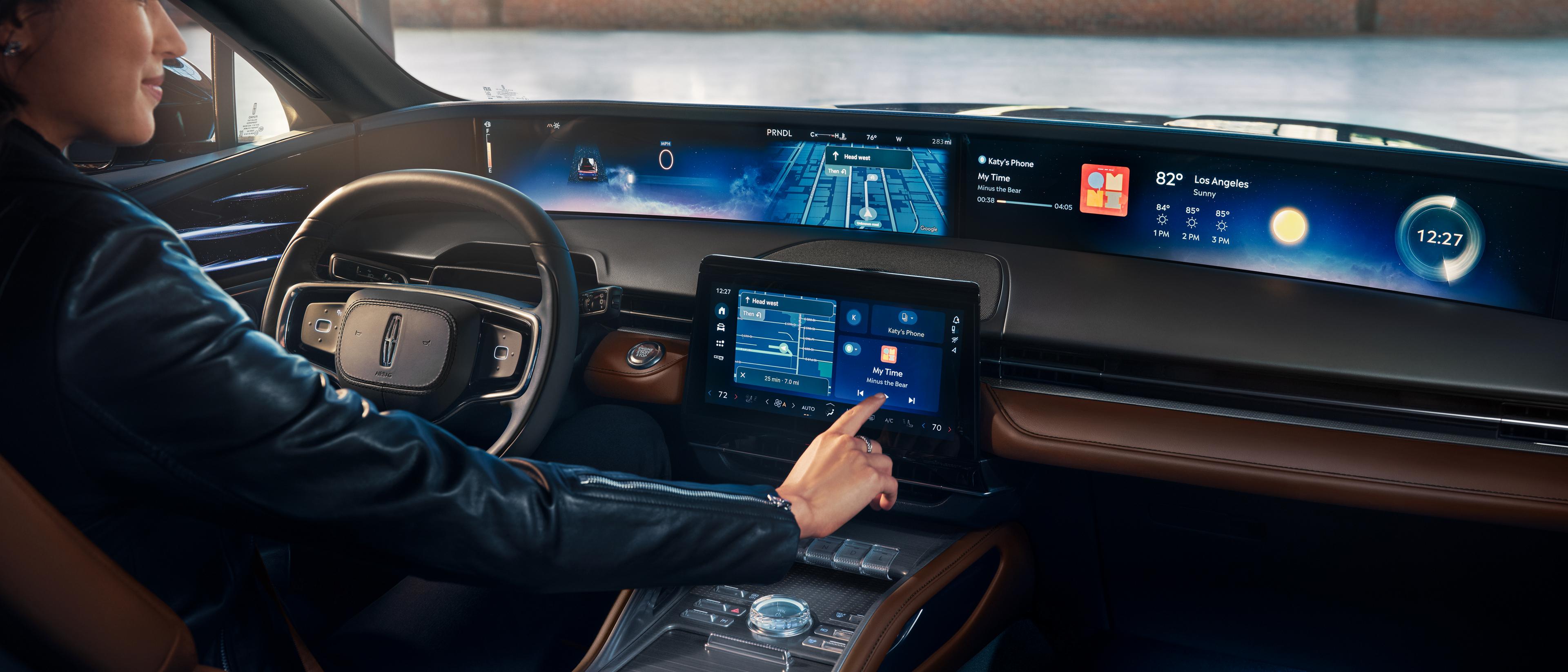 A person presses the center touch screen with their finger